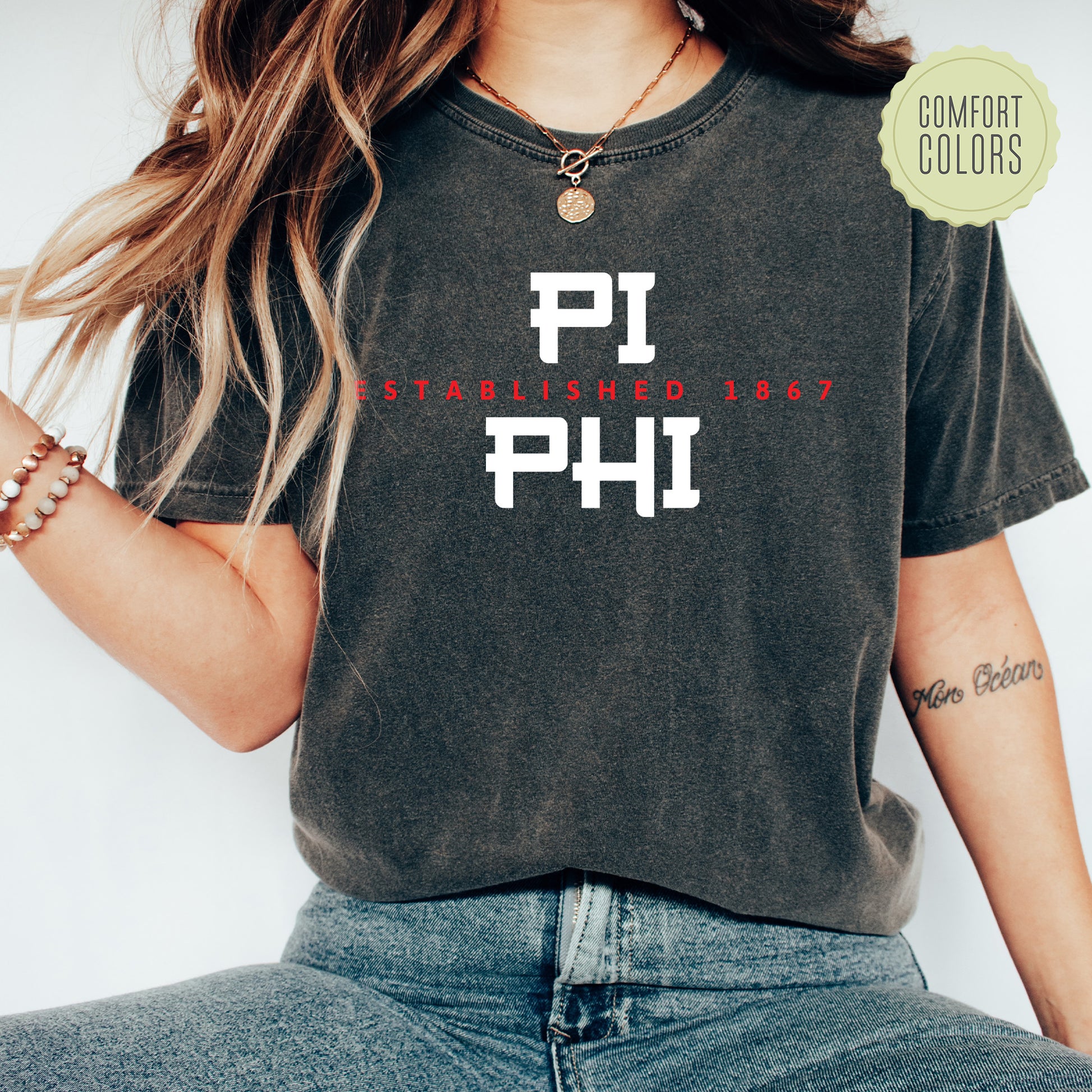 a woman wearing a black shirt with the word phi printed on it