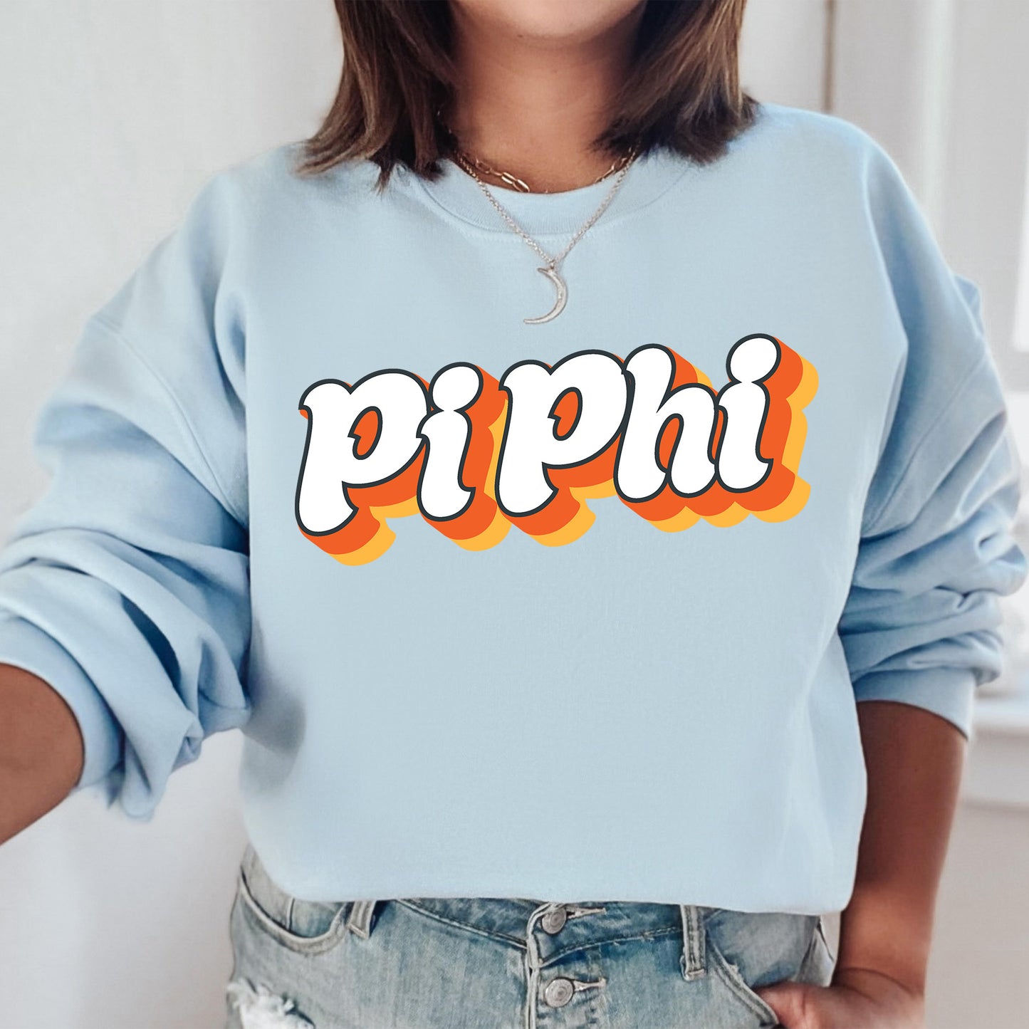 a woman wearing a blue sweatshirt with the word pippi on it