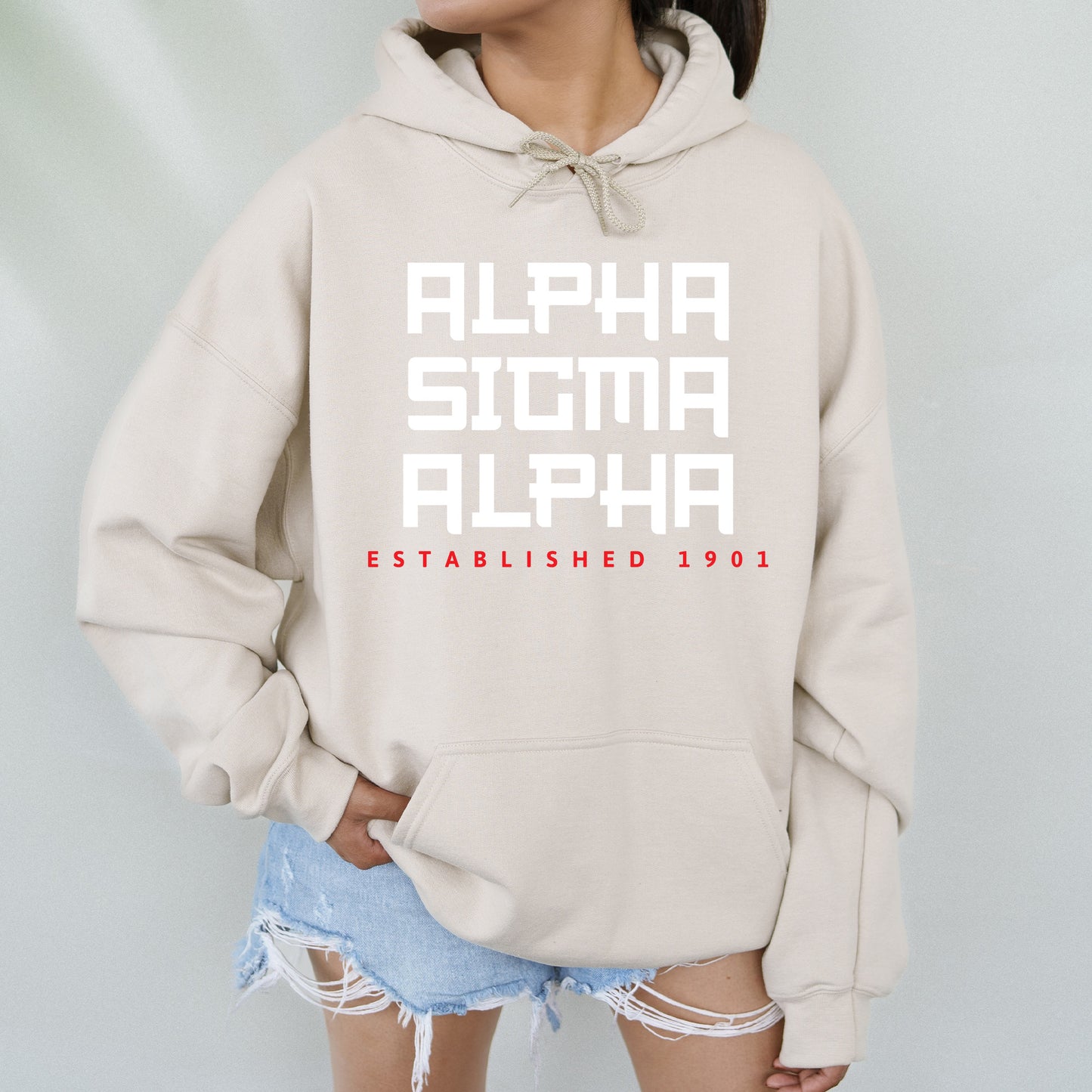 a woman wearing a sweatshirt with the words alpha and alpha printed on