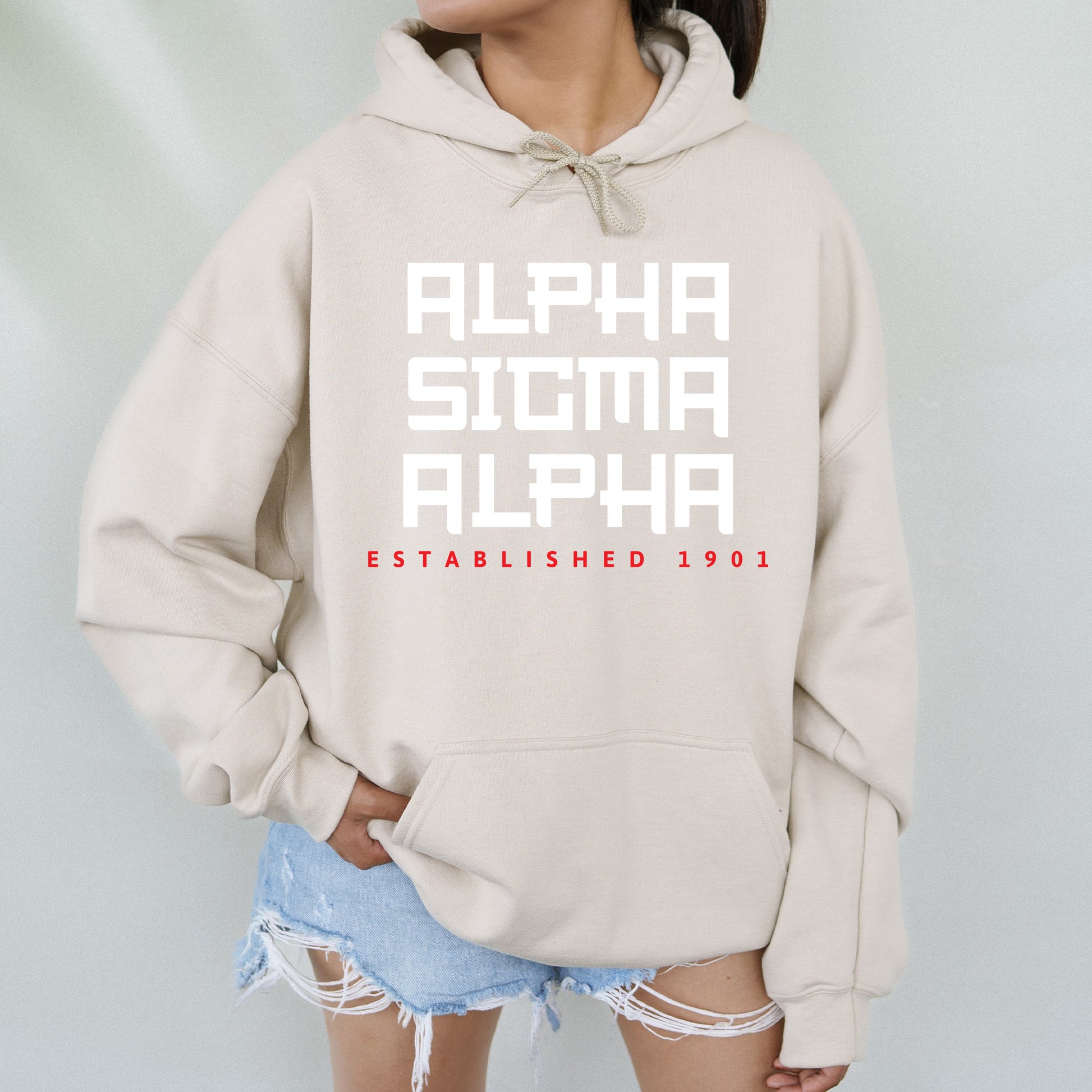 a woman wearing a sweatshirt with the words alpha and alpha printed on