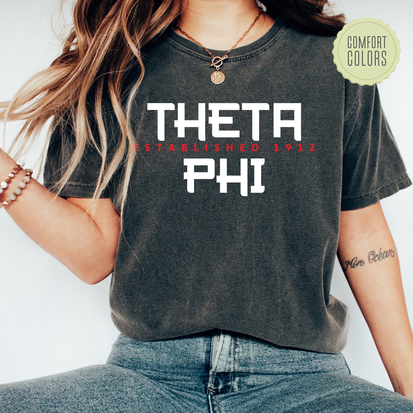 a woman wearing a black shirt with the words thera phi printed on it