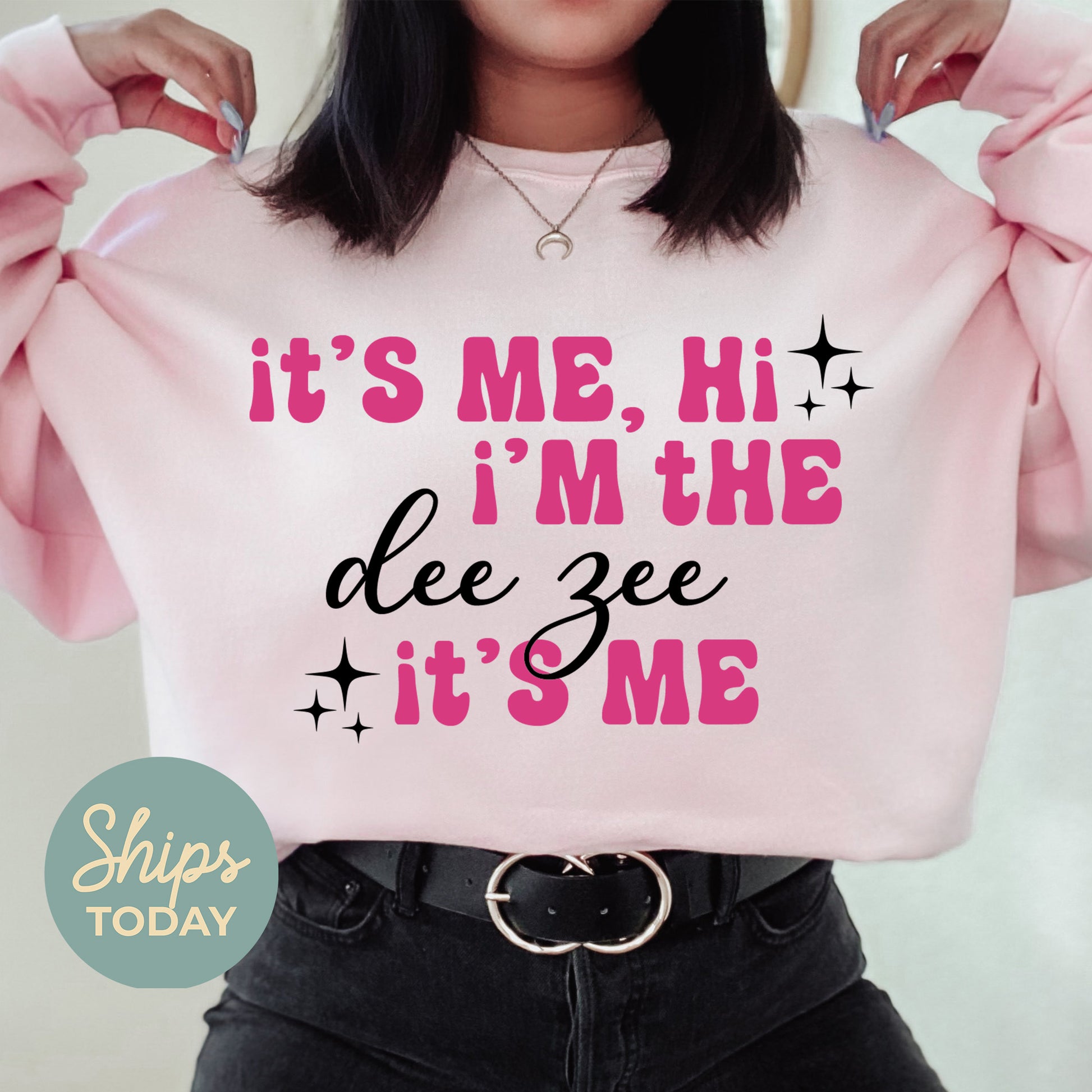 a woman wearing a pink sweatshirt that says it's me, i'm