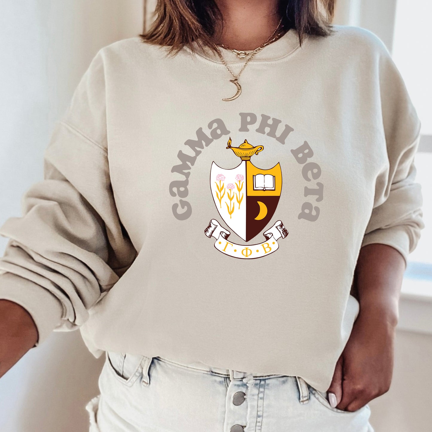 a woman wearing a sweatshirt with a crest on it