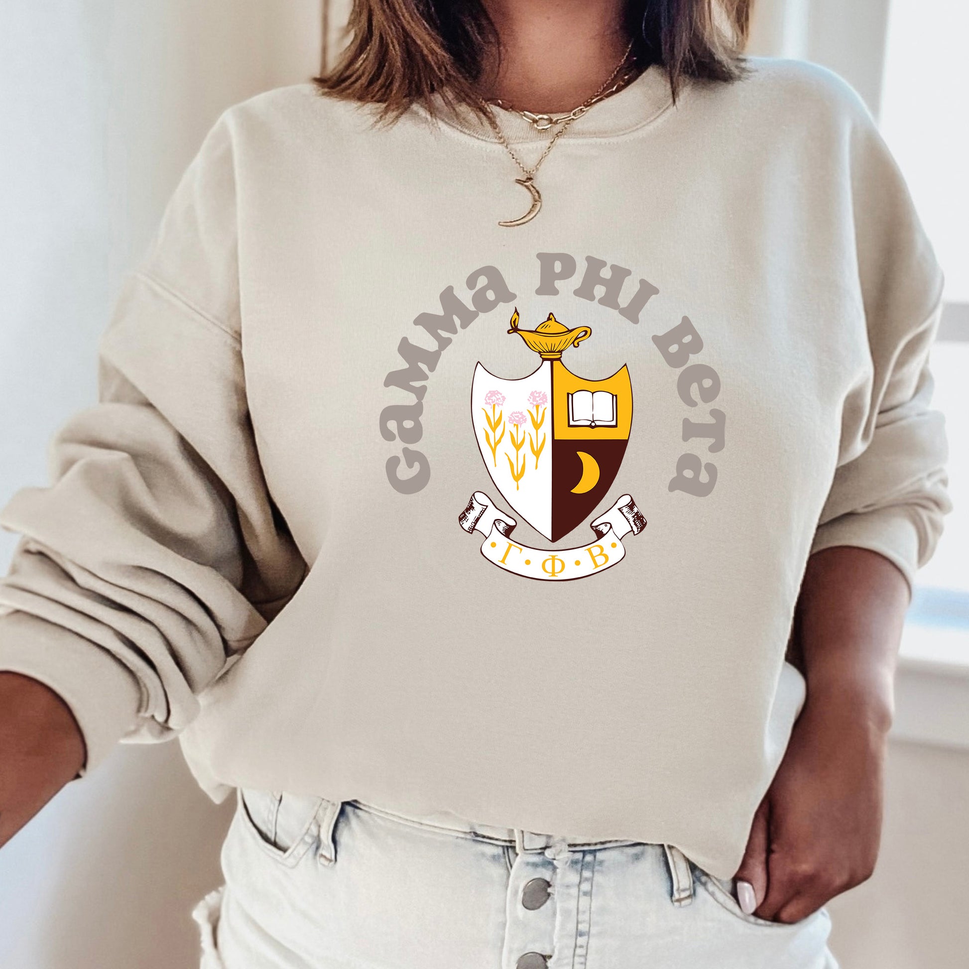 a woman wearing a sweatshirt with a crest on it