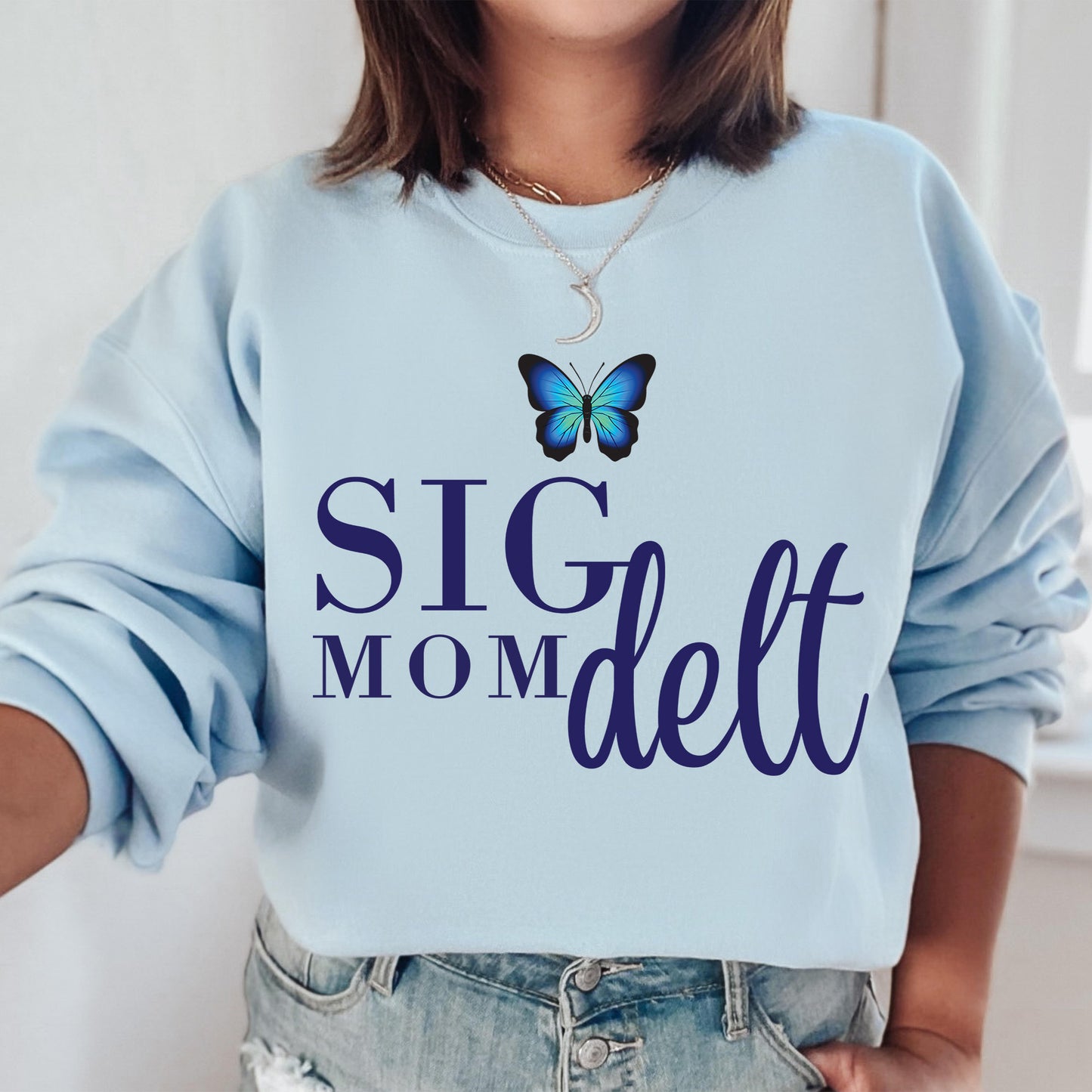 a woman wearing a blue sweatshirt with a butterfly on it