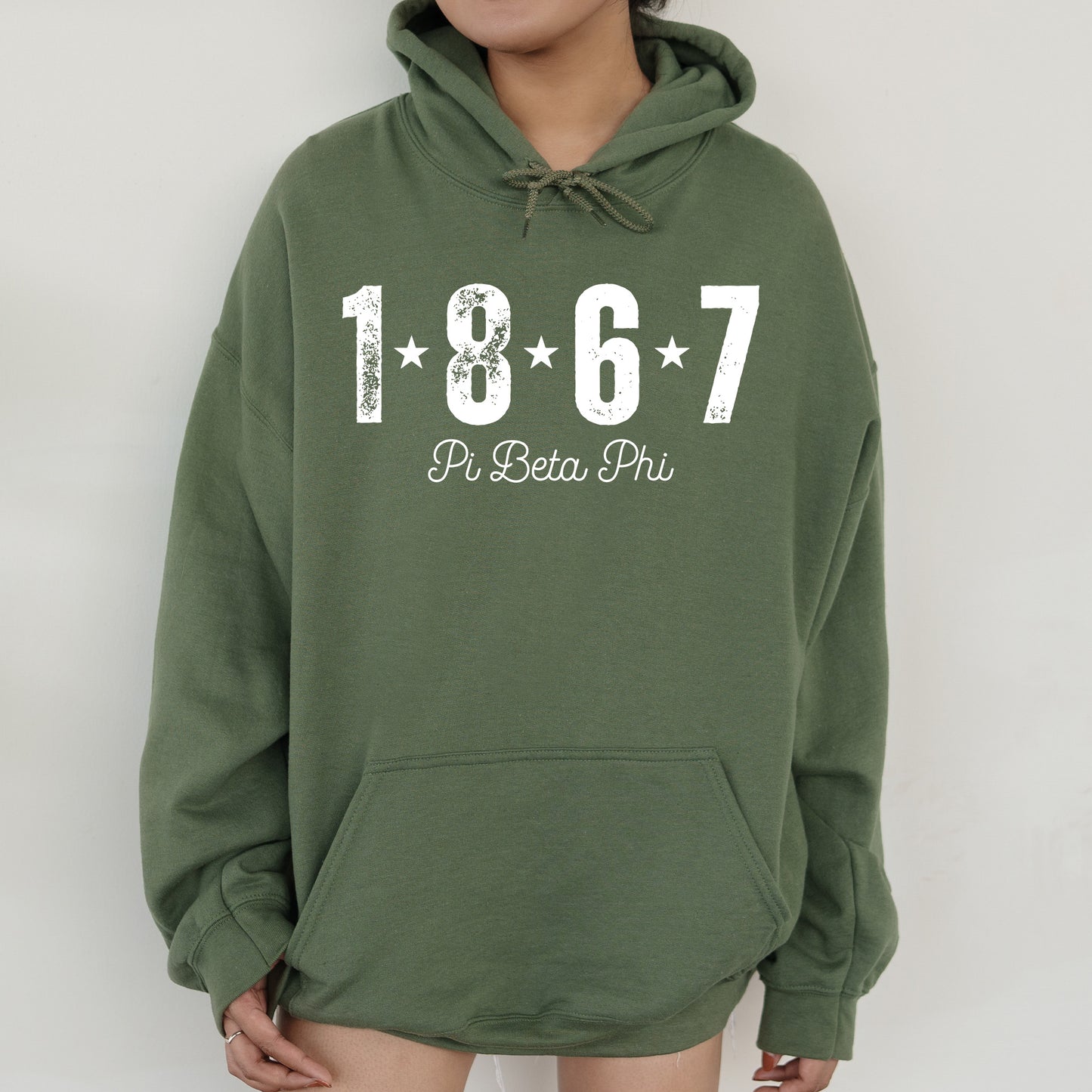 a woman wearing a green sweatshirt with a white number on it