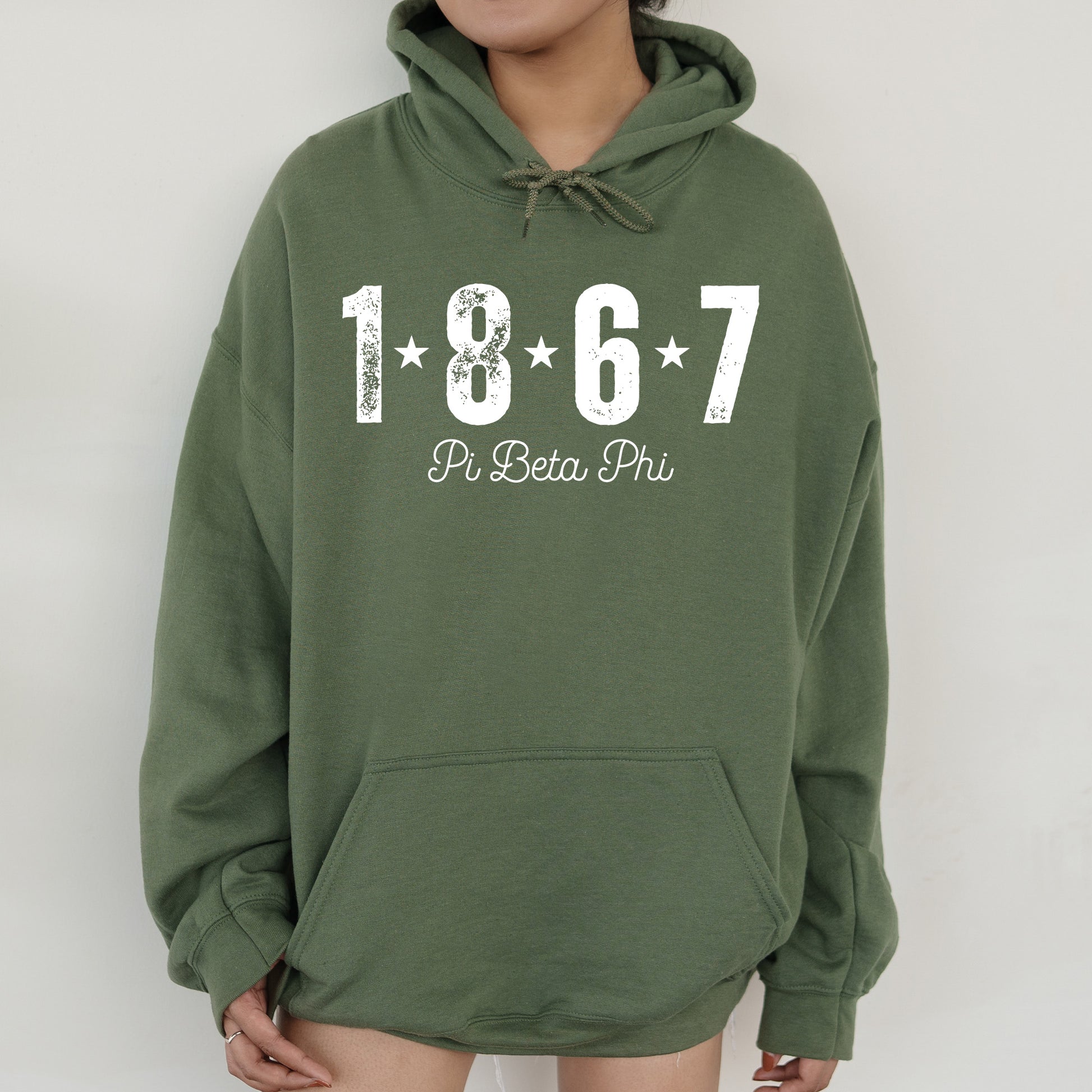 a woman wearing a green sweatshirt with a white number on it