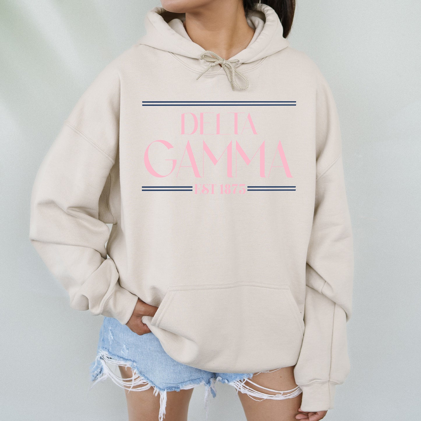 a woman wearing a white sweatshirt with pink lettering