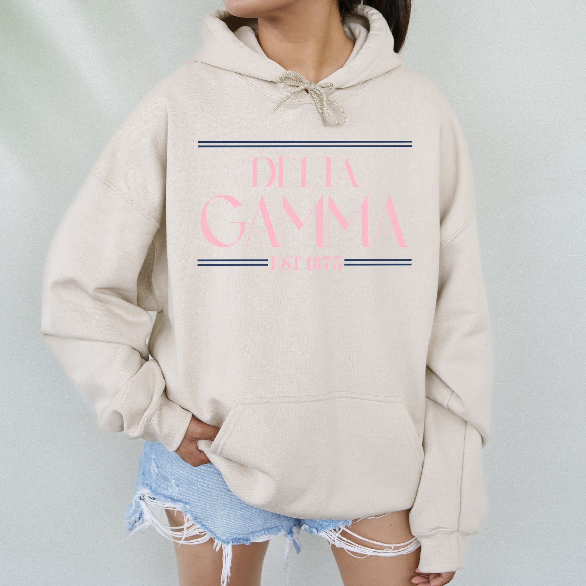 a woman wearing a white sweatshirt with pink lettering