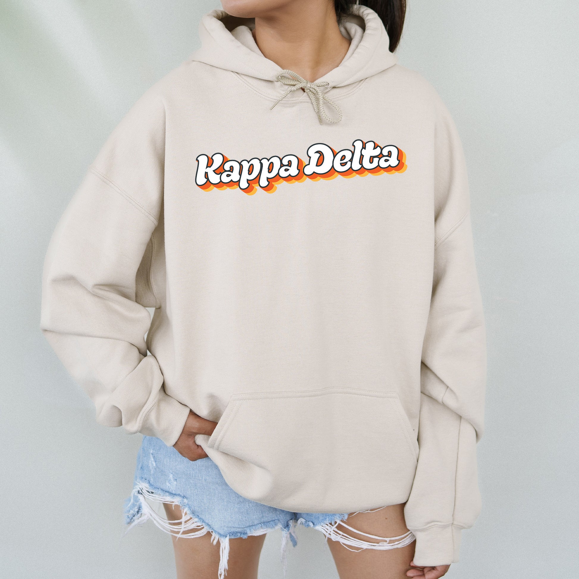 a woman wearing a hoodie that says kappa delta