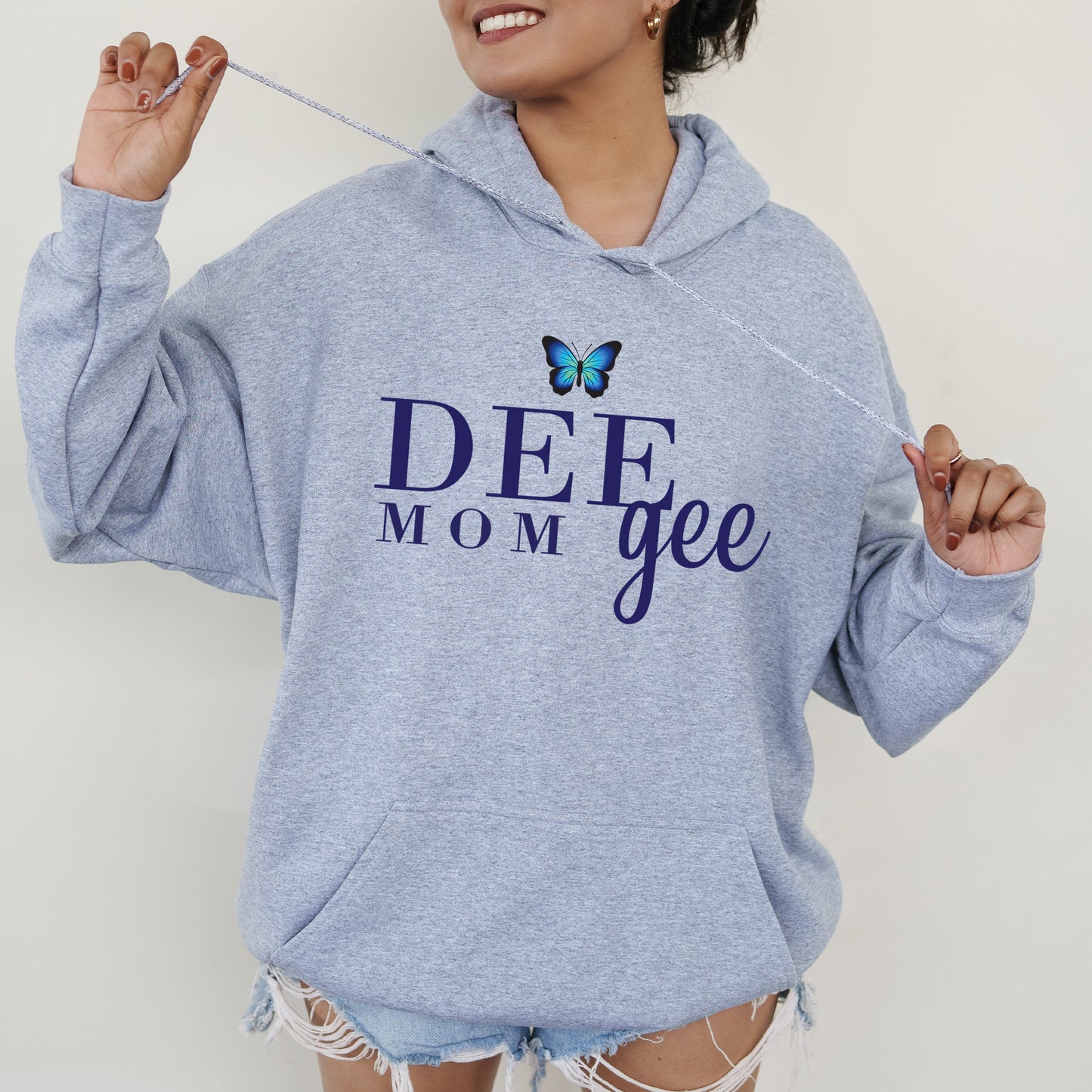 a woman wearing a blue hoodie with a butterfly on it