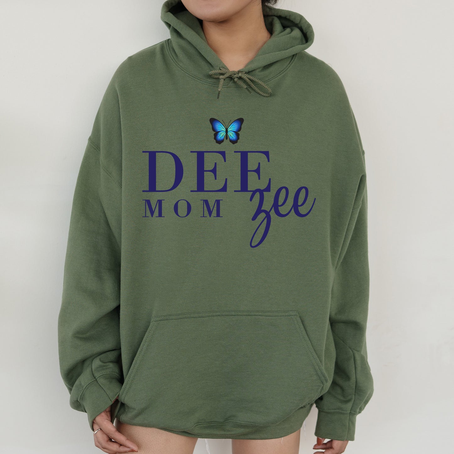 a woman wearing a green hoodie with a butterfly on it