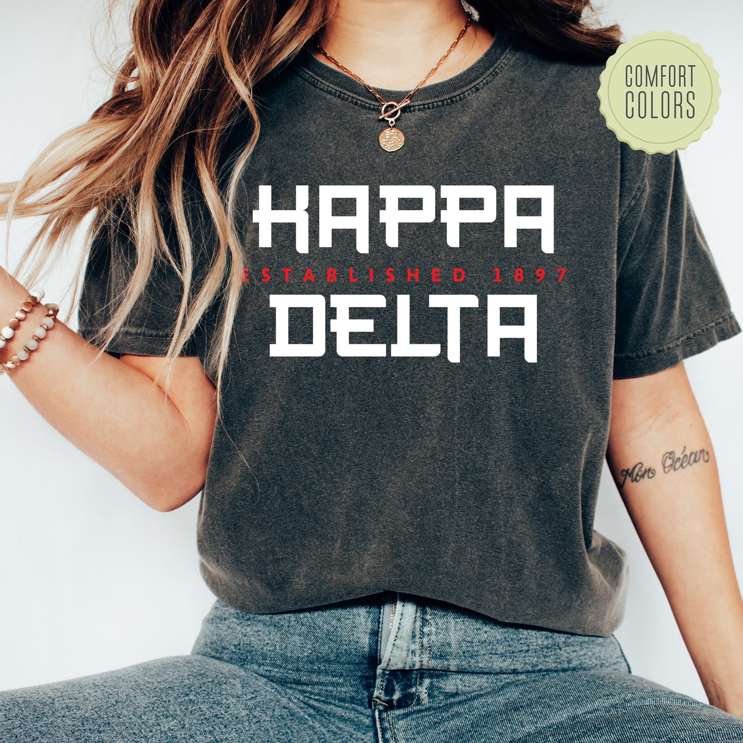a woman wearing a t - shirt with the words happy delta printed on it