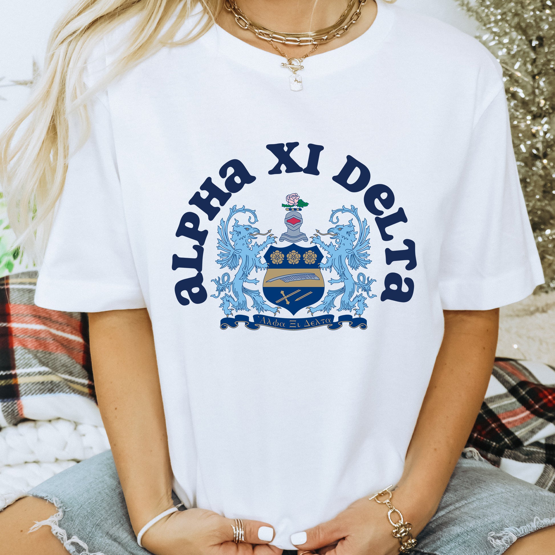 a woman wearing a white shirt with a blue and white crest on it