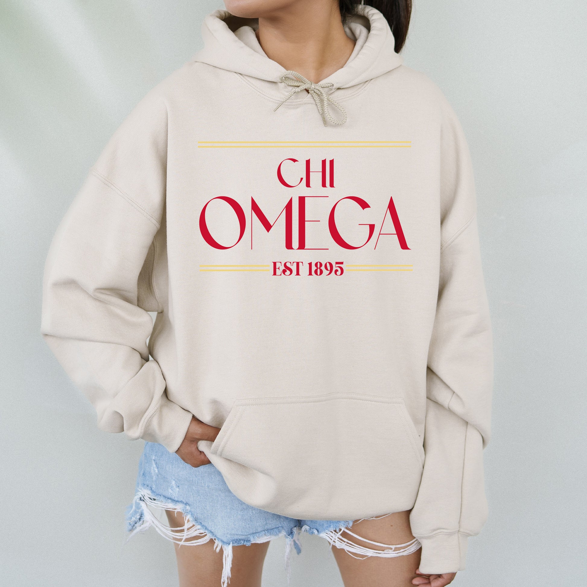 a woman wearing a white hoodie with a red omega on it