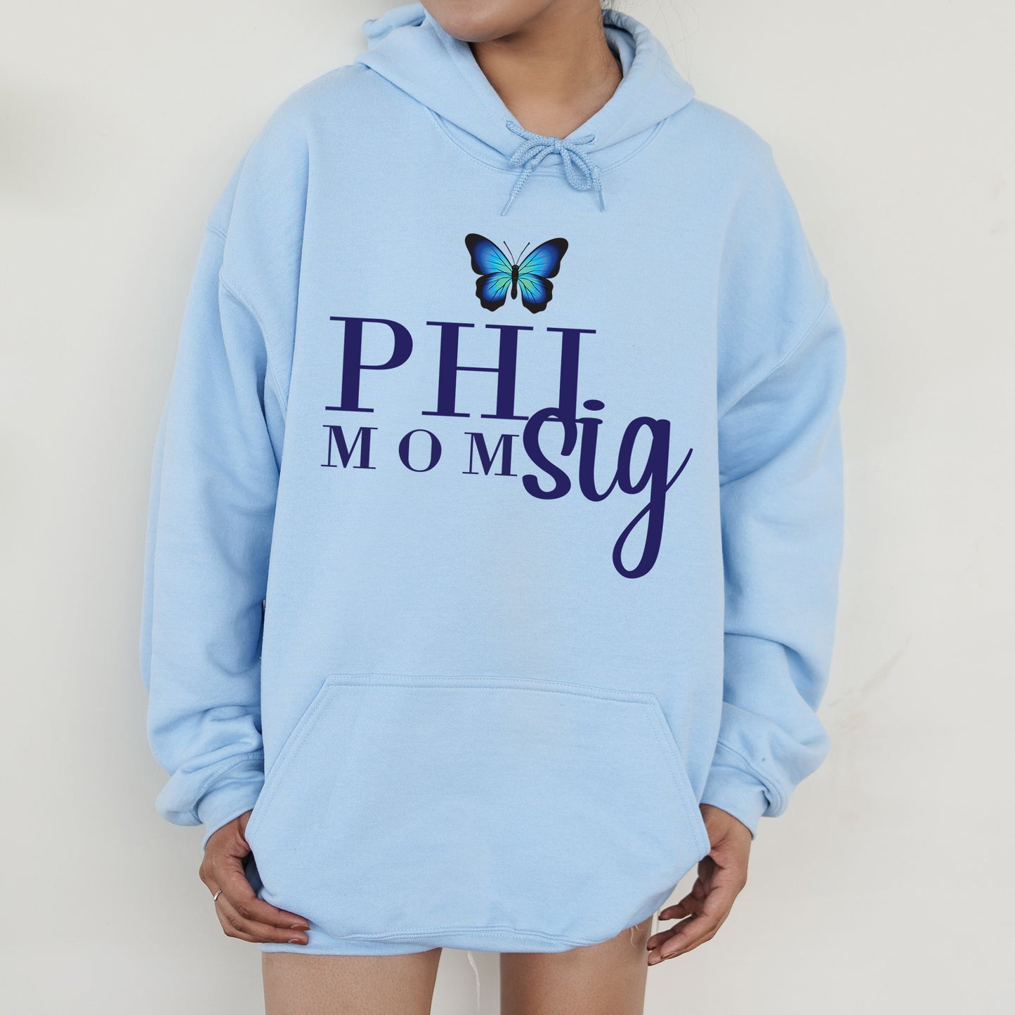 a woman wearing a blue hoodie with a butterfly on it