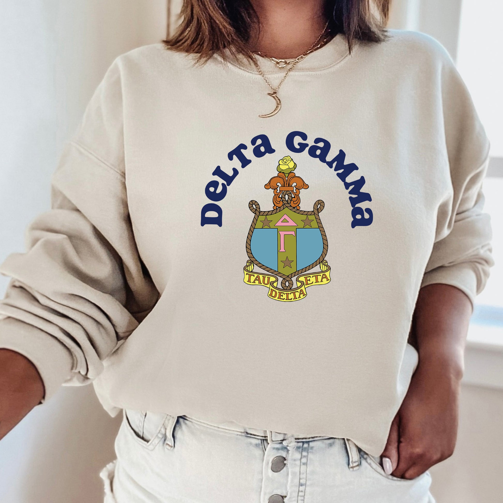 a woman wearing a sweatshirt that says delta gama