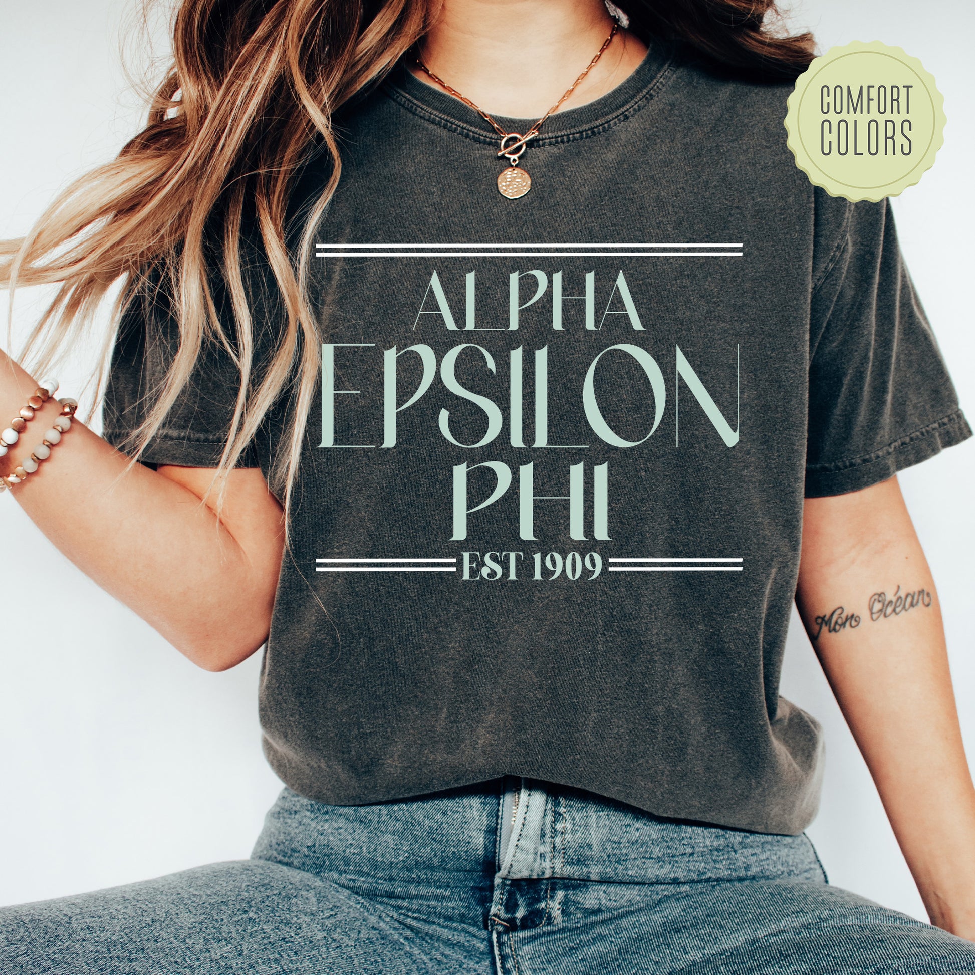 a woman wearing a black shirt with the words alpha epsilon phil on it