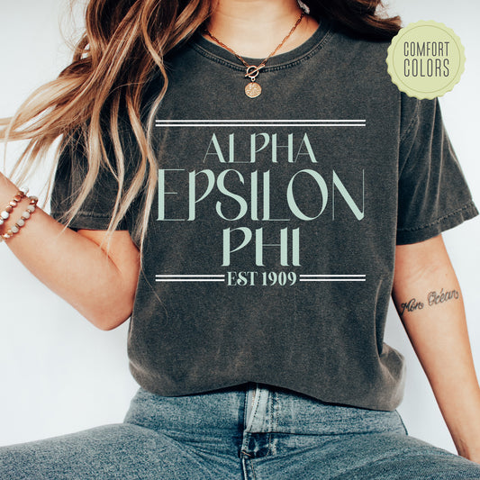a woman wearing a black shirt with the words alpha epsilon phil on it