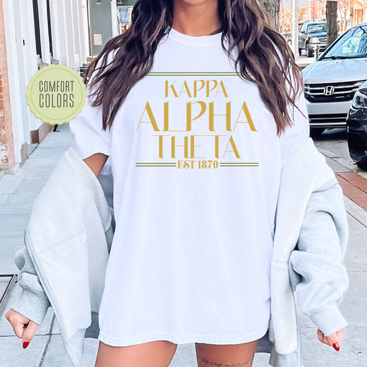 a woman wearing a white shirt with gold letters