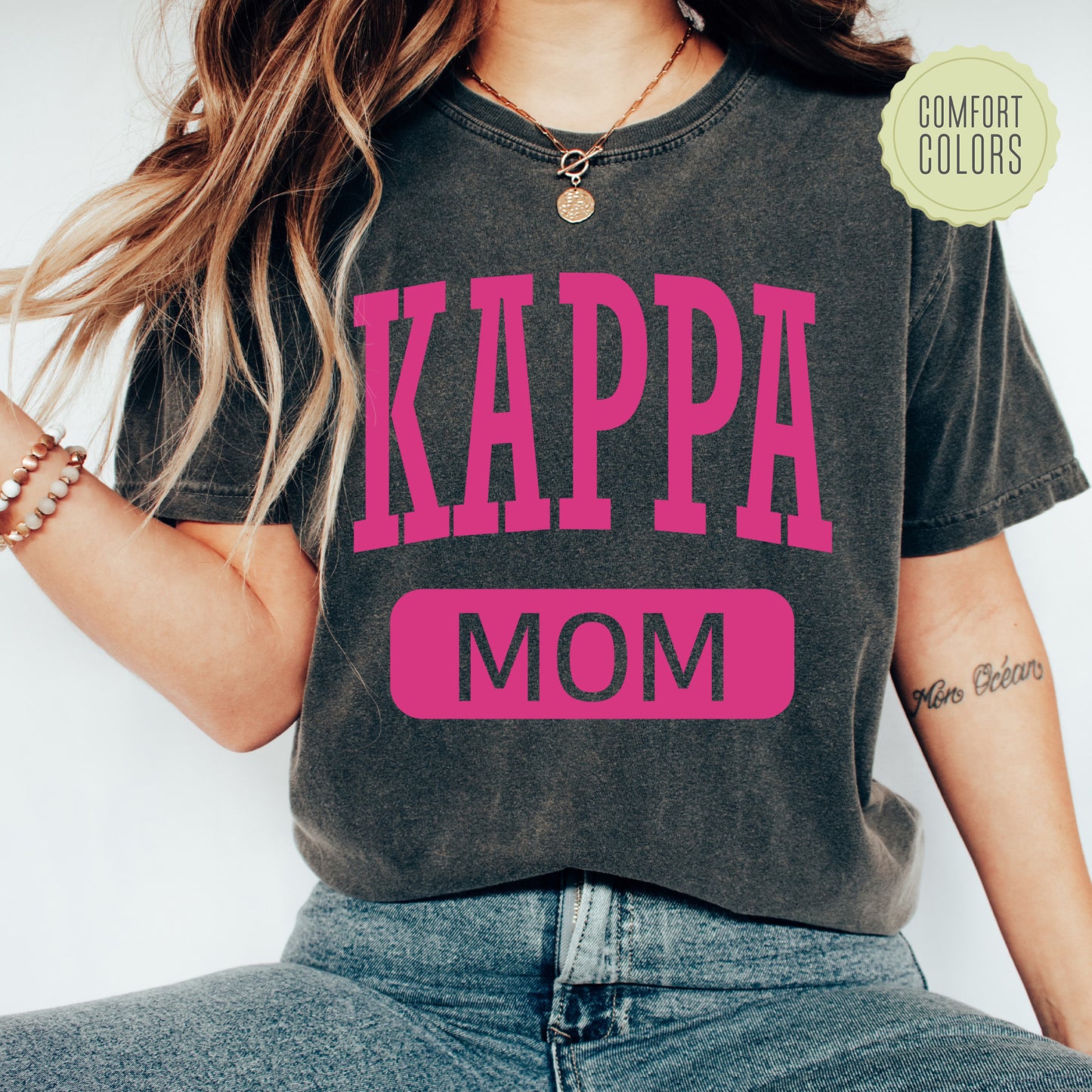 a woman wearing a t - shirt that says kappa mom