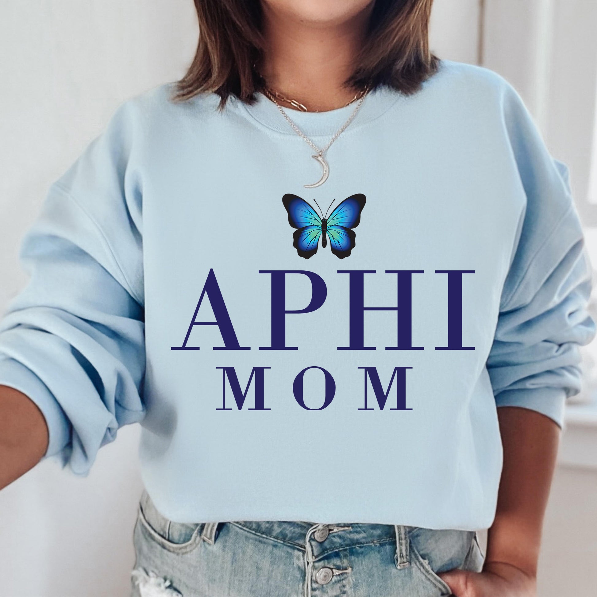 a woman wearing a blue sweatshirt with a butterfly on it