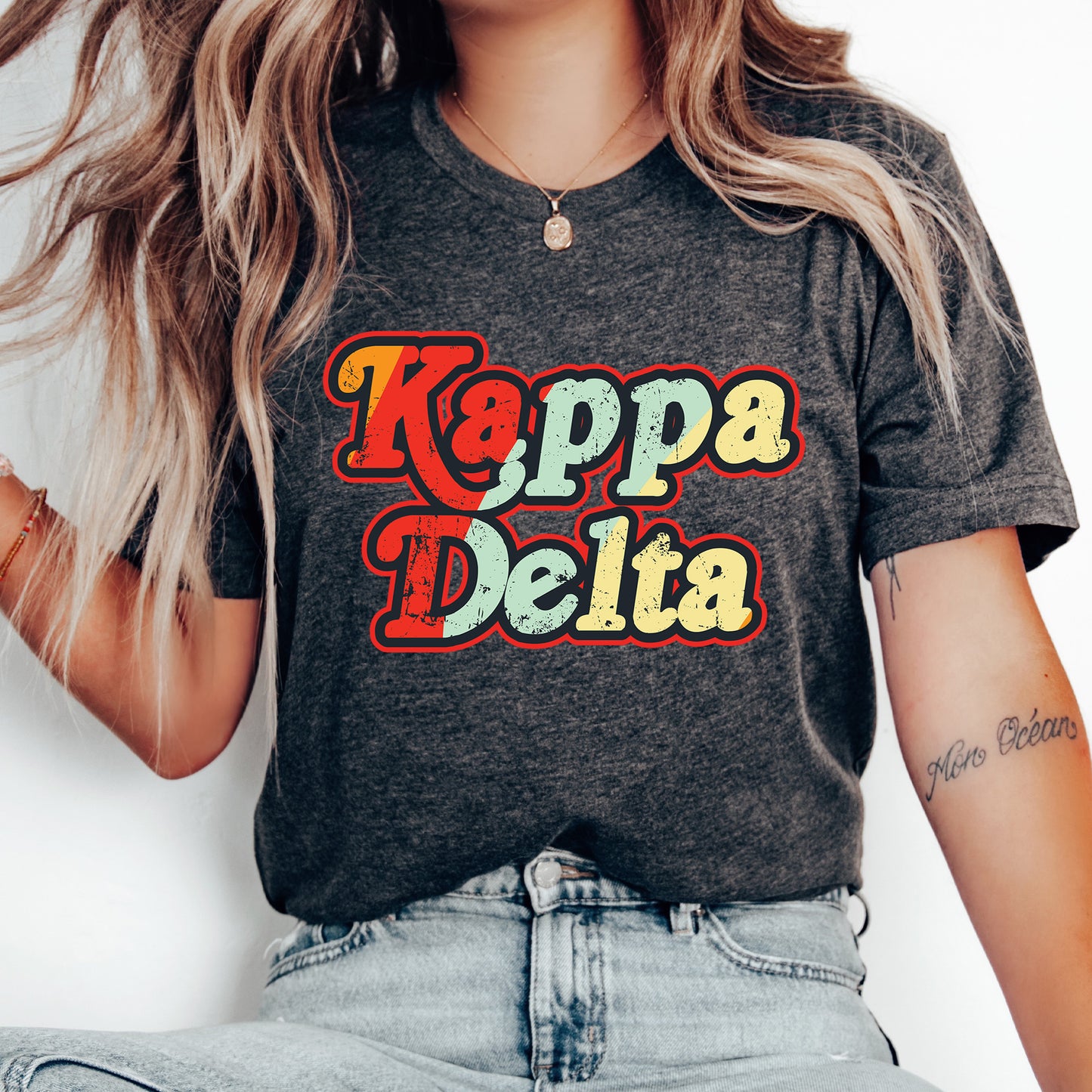 a woman wearing a t - shirt that says kappa delta