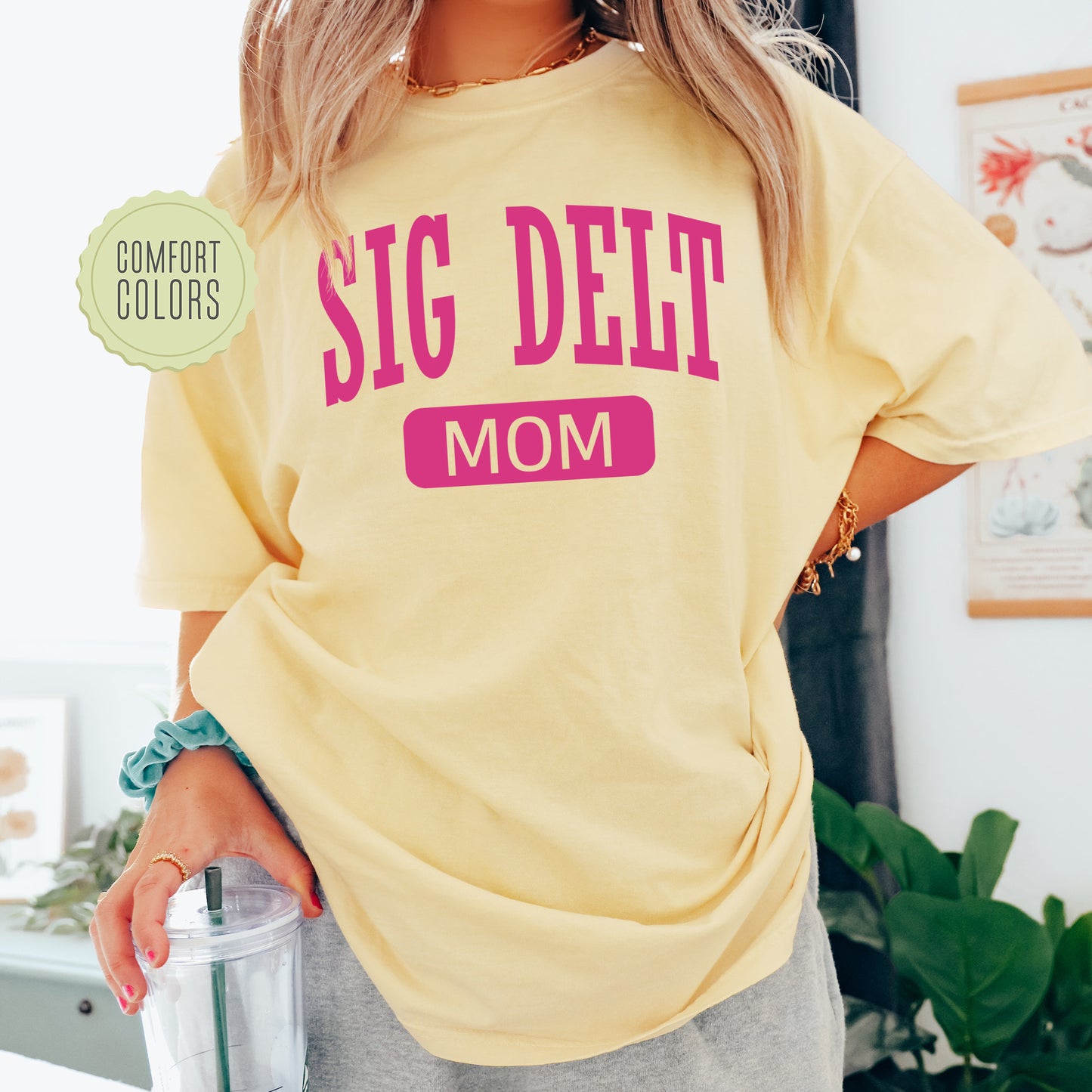 a woman in a yellow shirt holding a blender