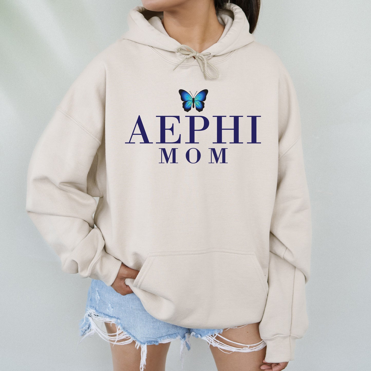 a woman wearing a sweatshirt with a butterfly on it