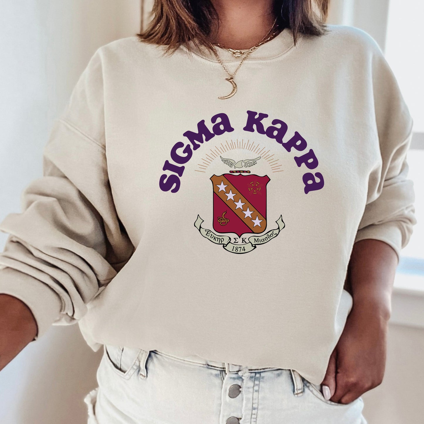 a woman wearing a sweater with a crest on it