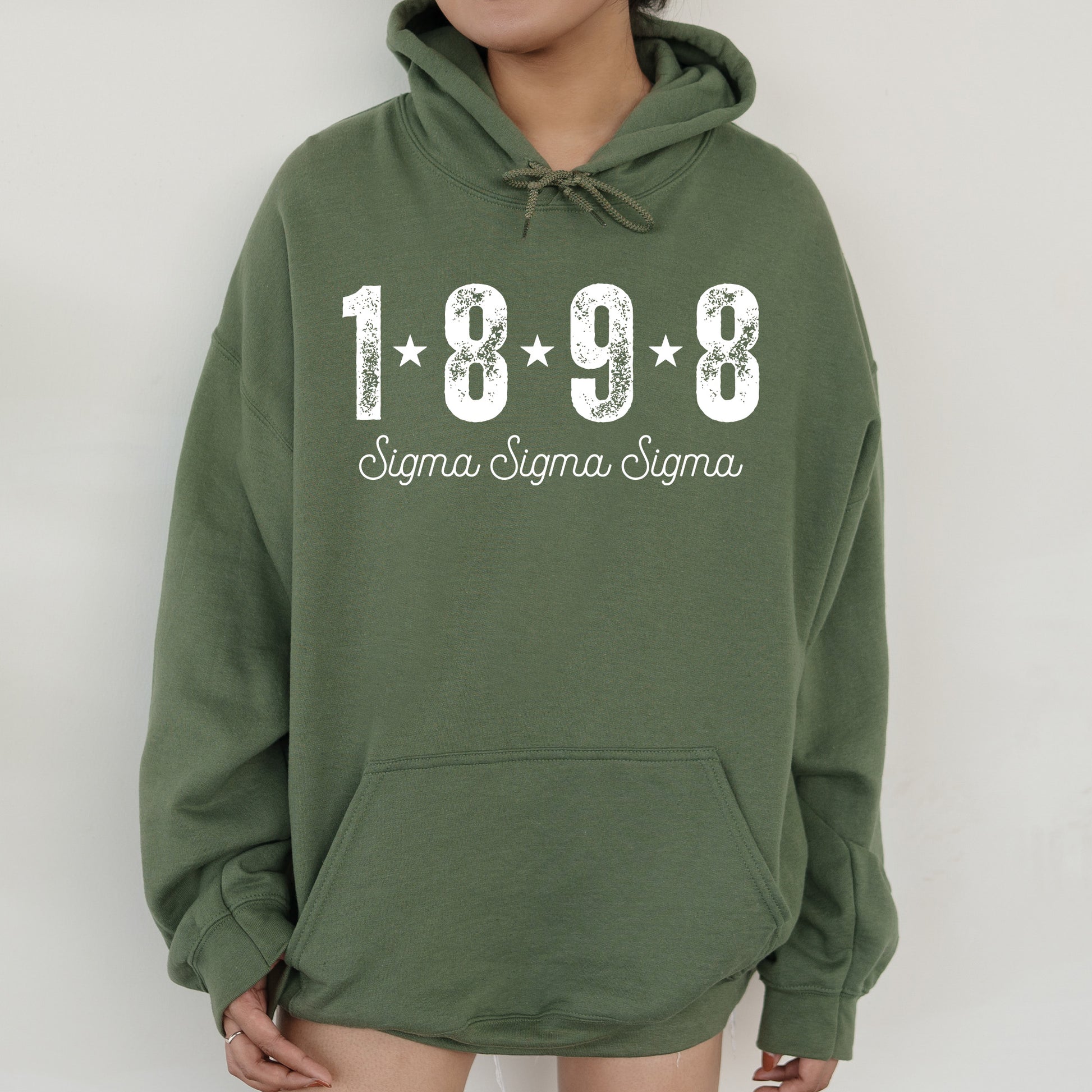 a woman wearing a green hoodie with the year 1989 printed on it