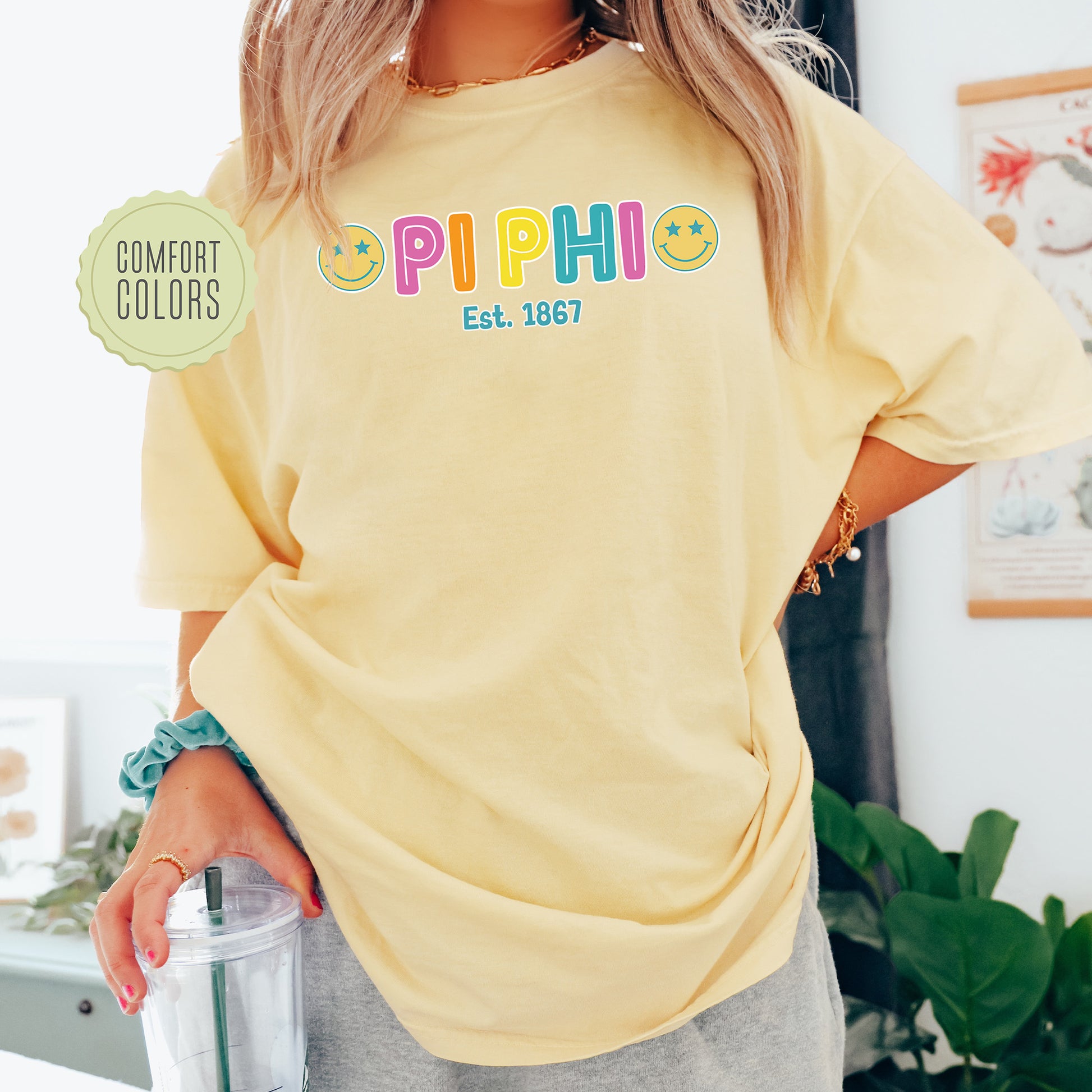 a woman in a yellow shirt holding a blender