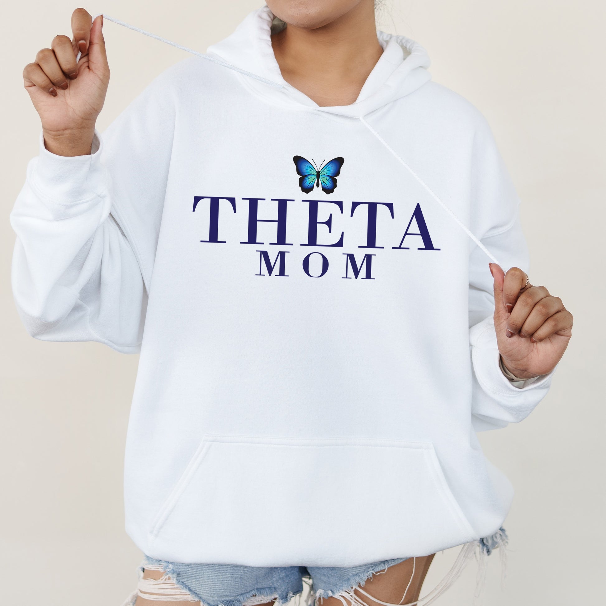 a woman in a white hoodie with a butterfly on it