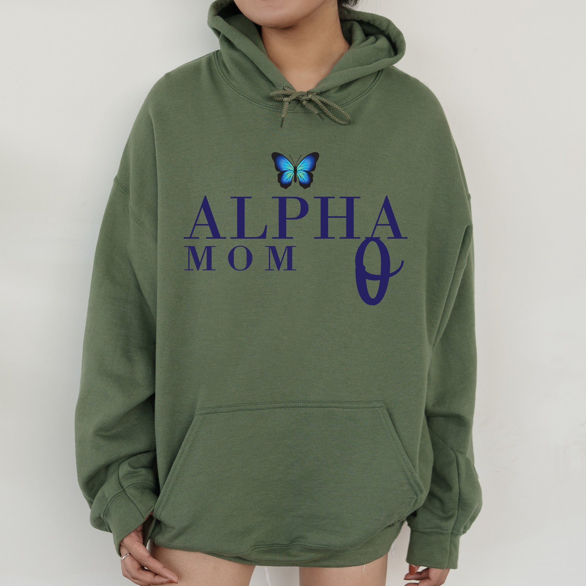 a woman wearing a green hoodie with a butterfly on it
