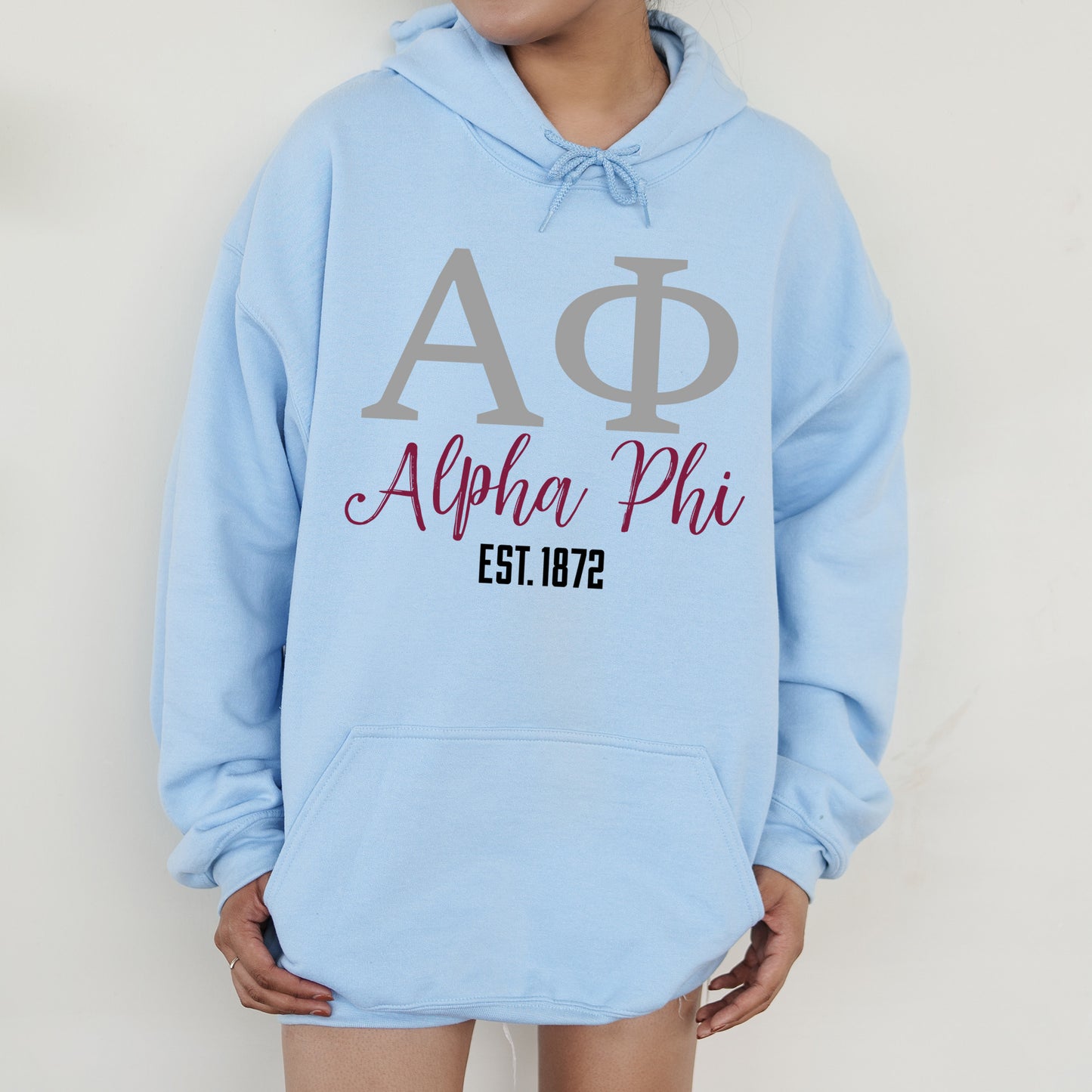 a person wearing a blue hoodie with a phi phi on it