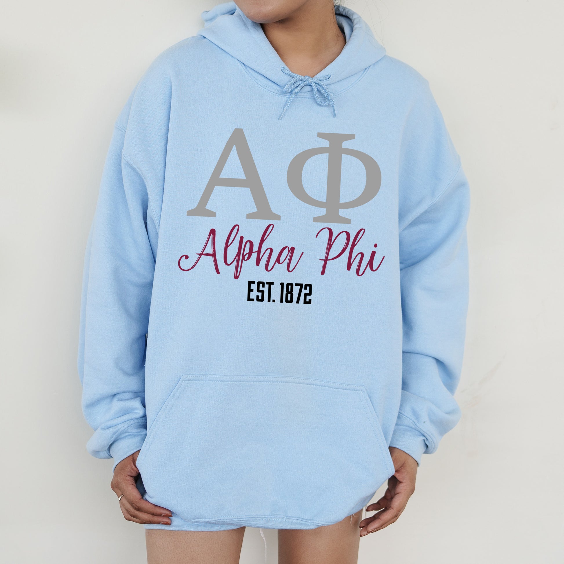 a person wearing a blue hoodie with a phi phi on it