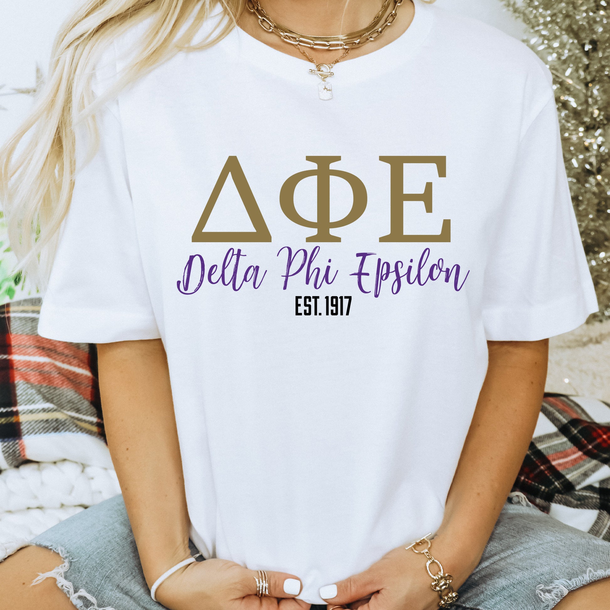 a woman wearing a white shirt that says ape delta phi epiloon