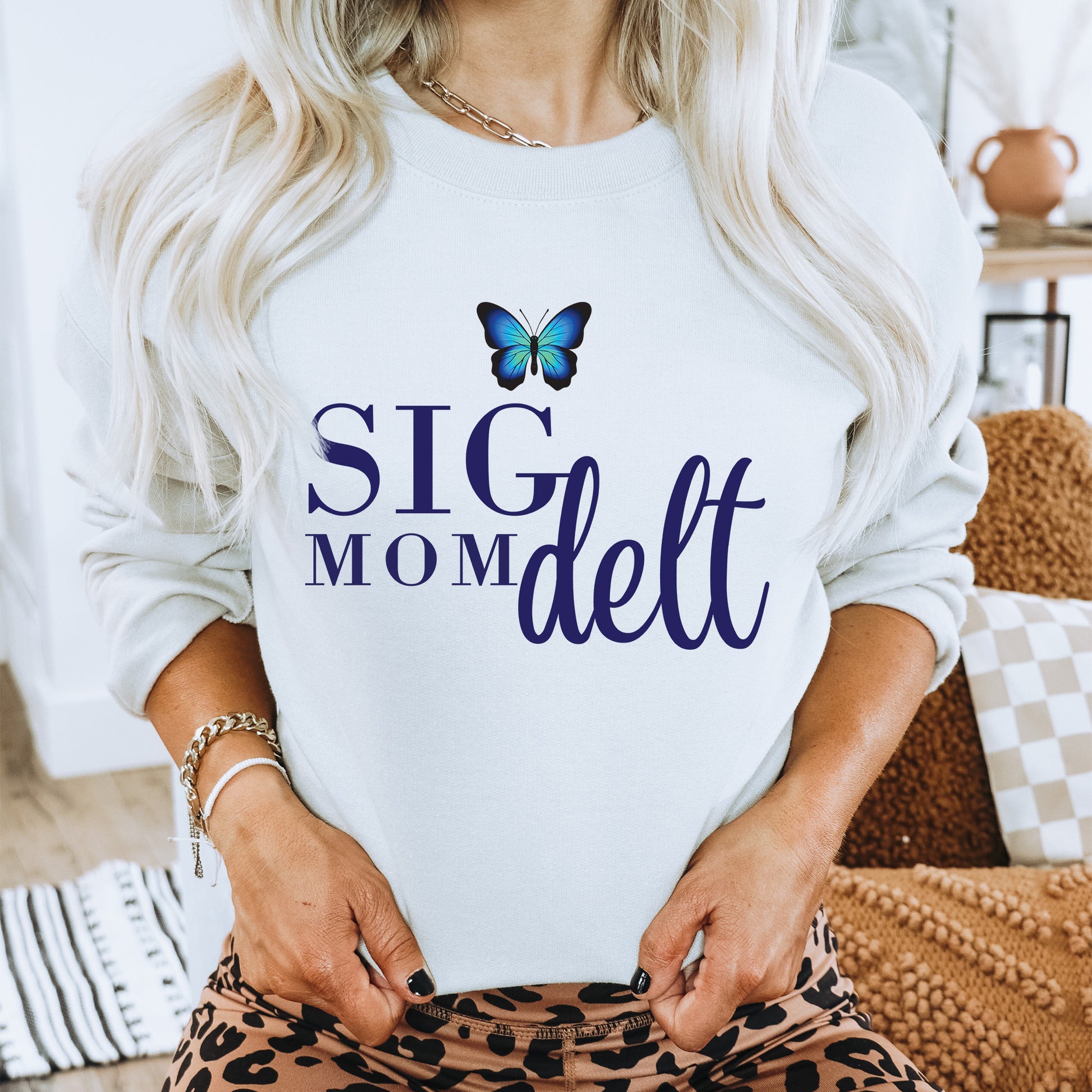 a woman wearing a sweatshirt with a butterfly on it
