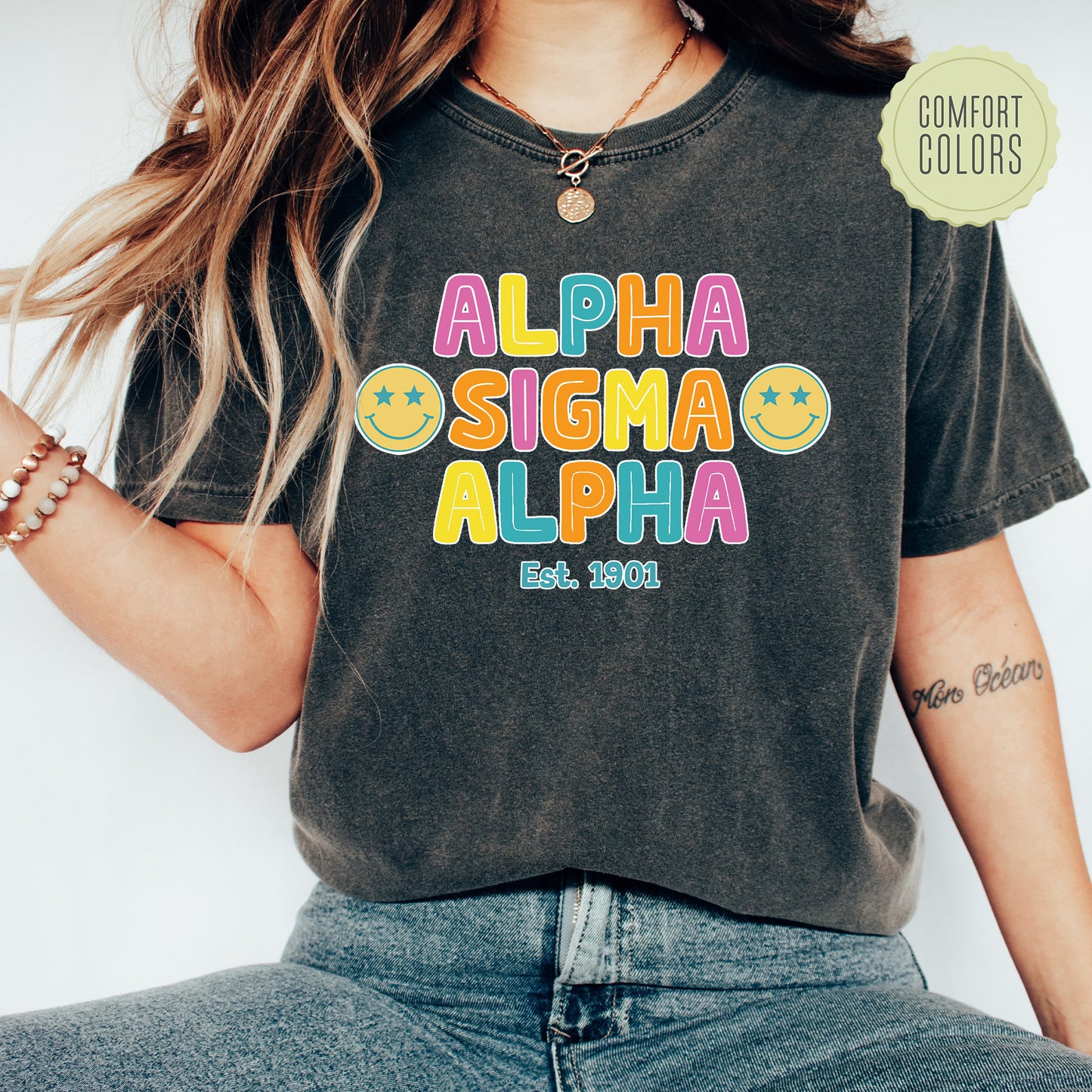 a woman wearing a black shirt with the word aloha on it