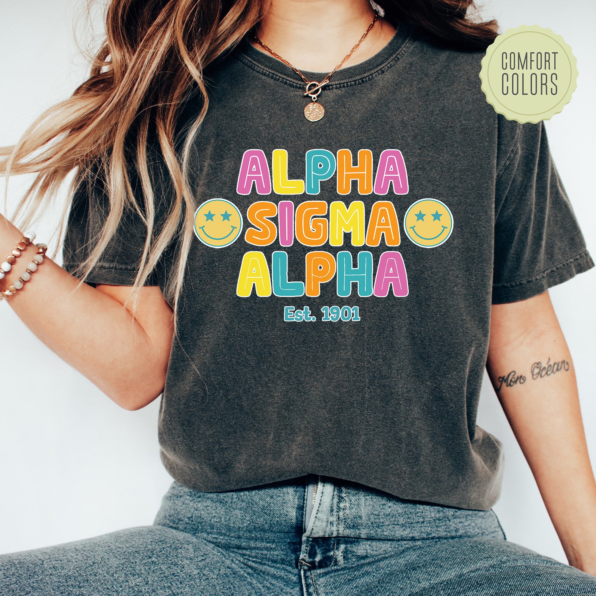 a woman wearing a black shirt with the word aloha on it