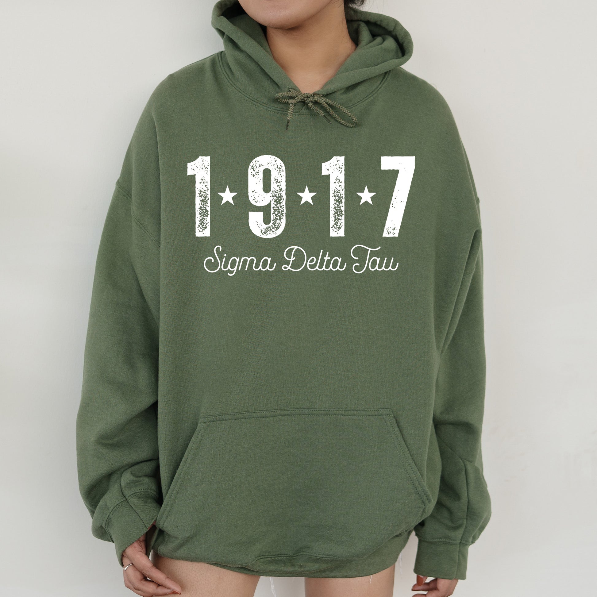 a woman wearing a green hoodie with the number 1917 printed on it