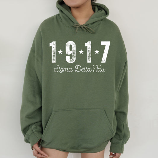 a woman wearing a green hoodie with the number 1917 printed on it