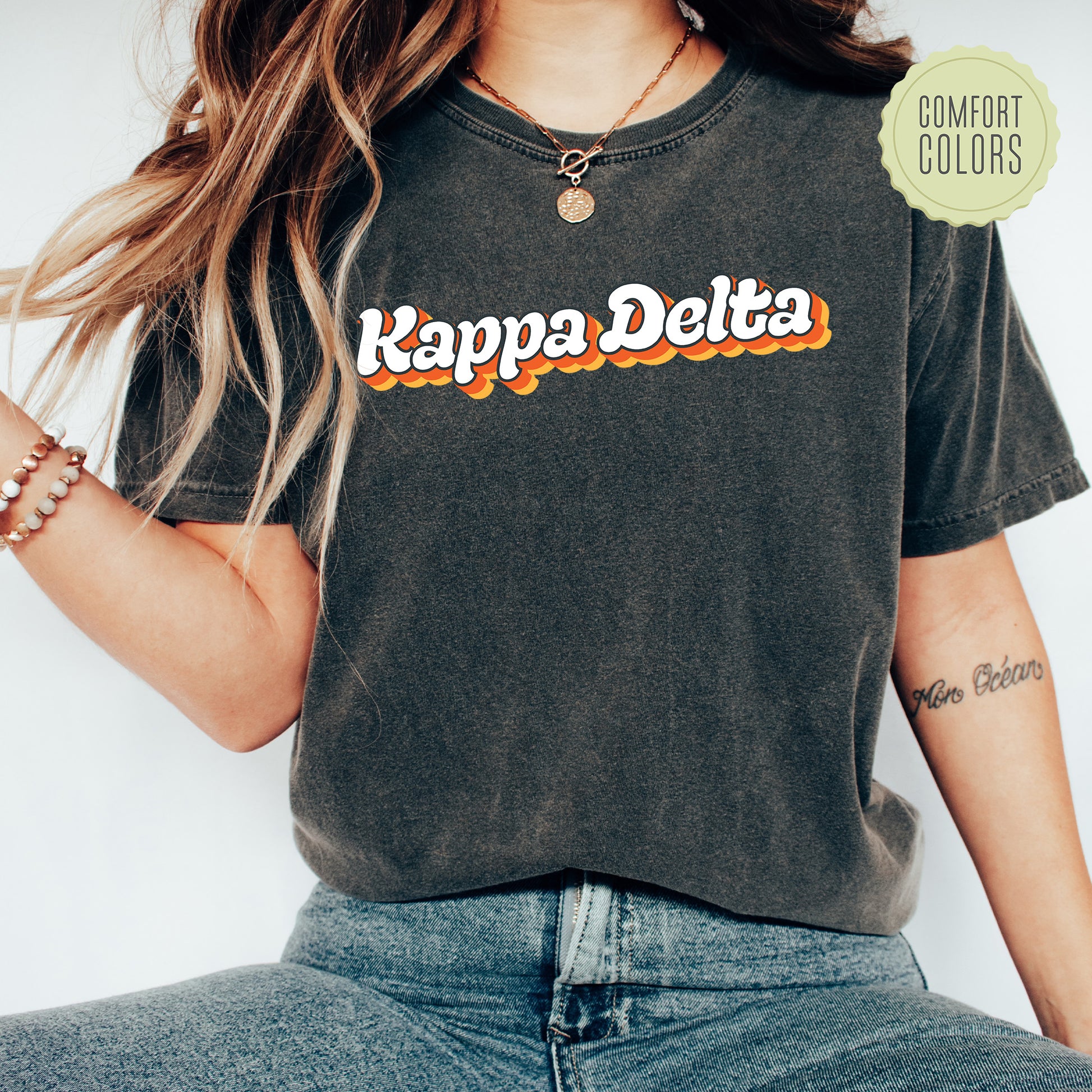 a woman wearing a t - shirt that says kappa delta