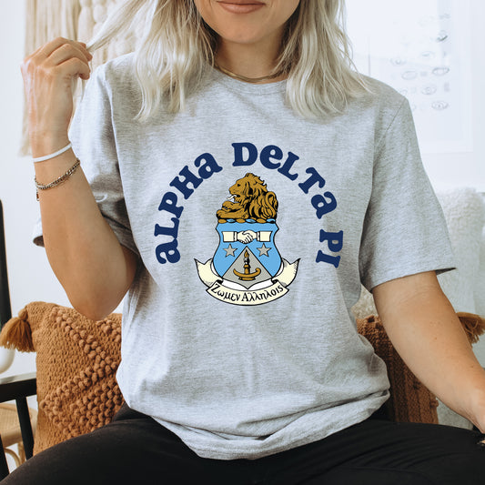 a woman sitting on a chair wearing a delta delta shirt