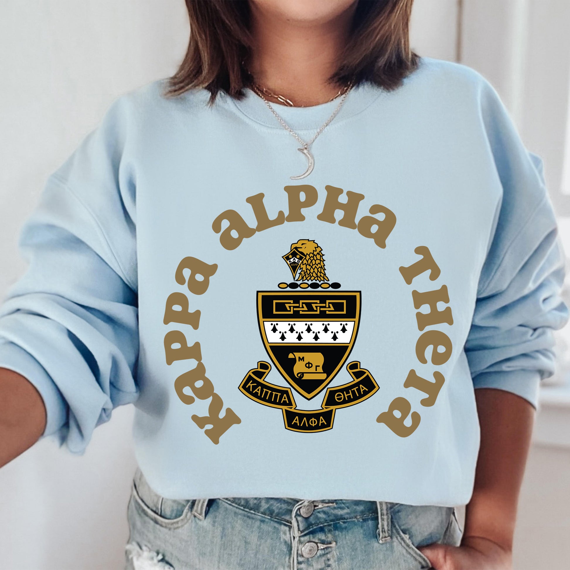 a woman wearing a blue sweatshirt with a lion on it