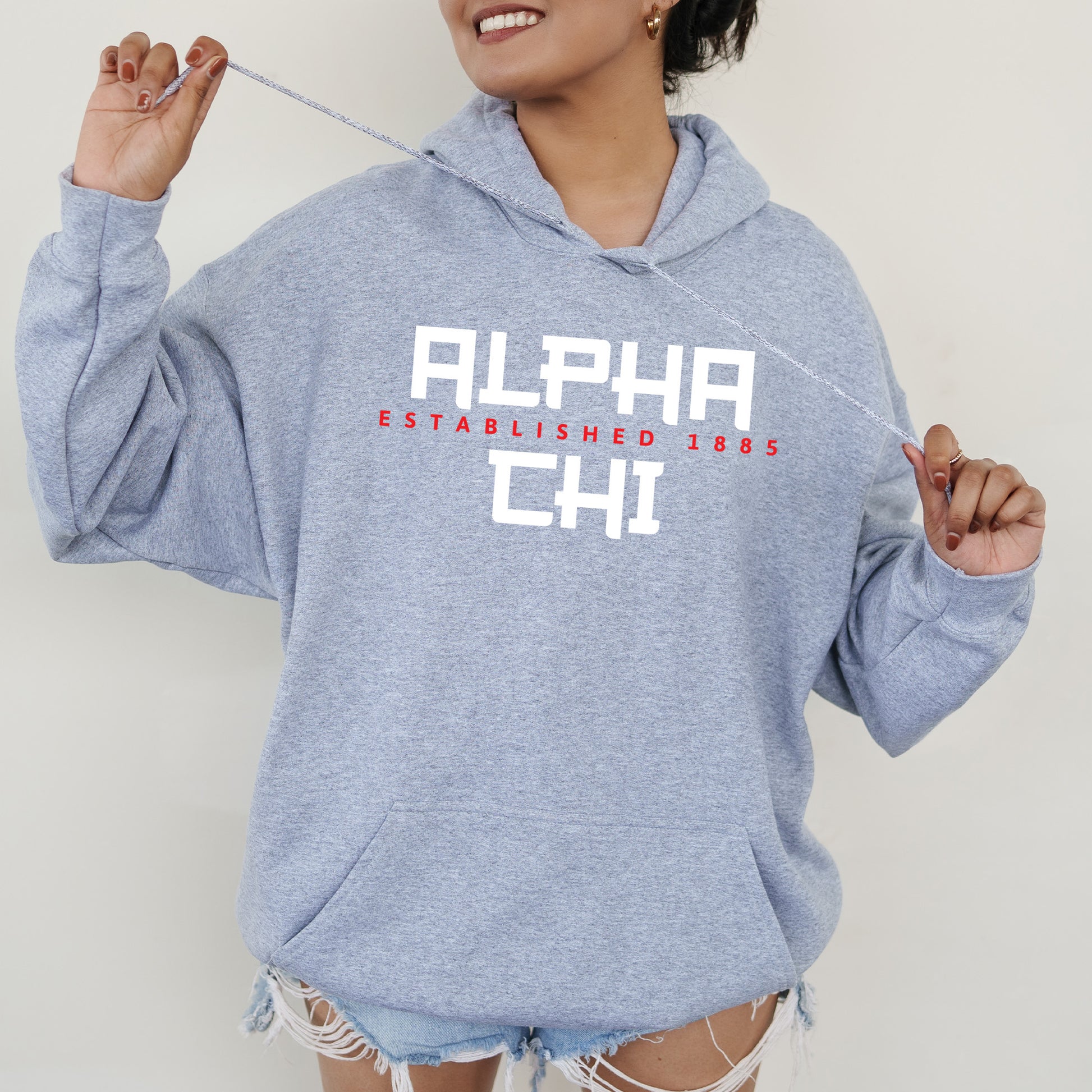 a woman in a blue hoodie is holding a toothbrush