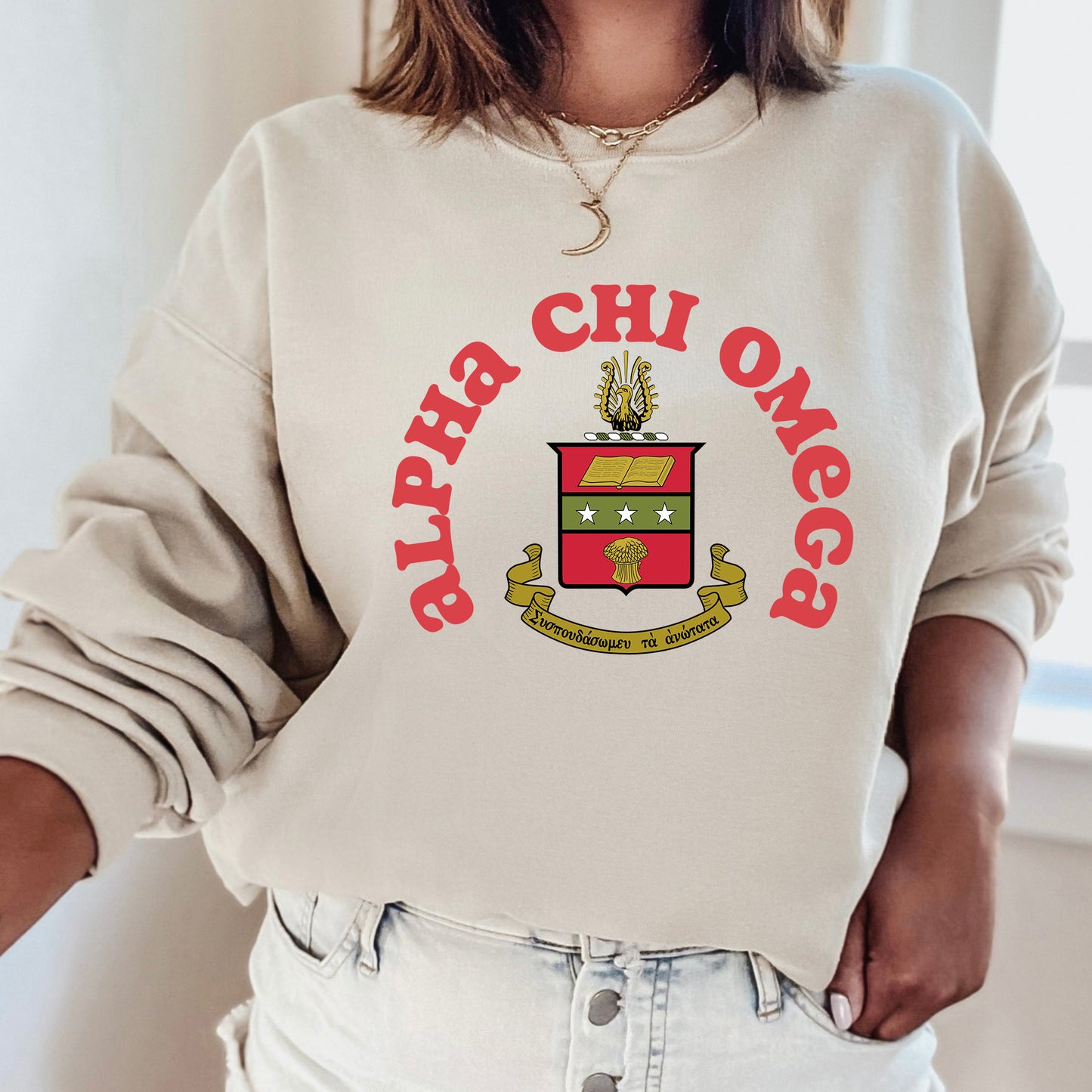 a woman wearing a sweatshirt with a crest on it