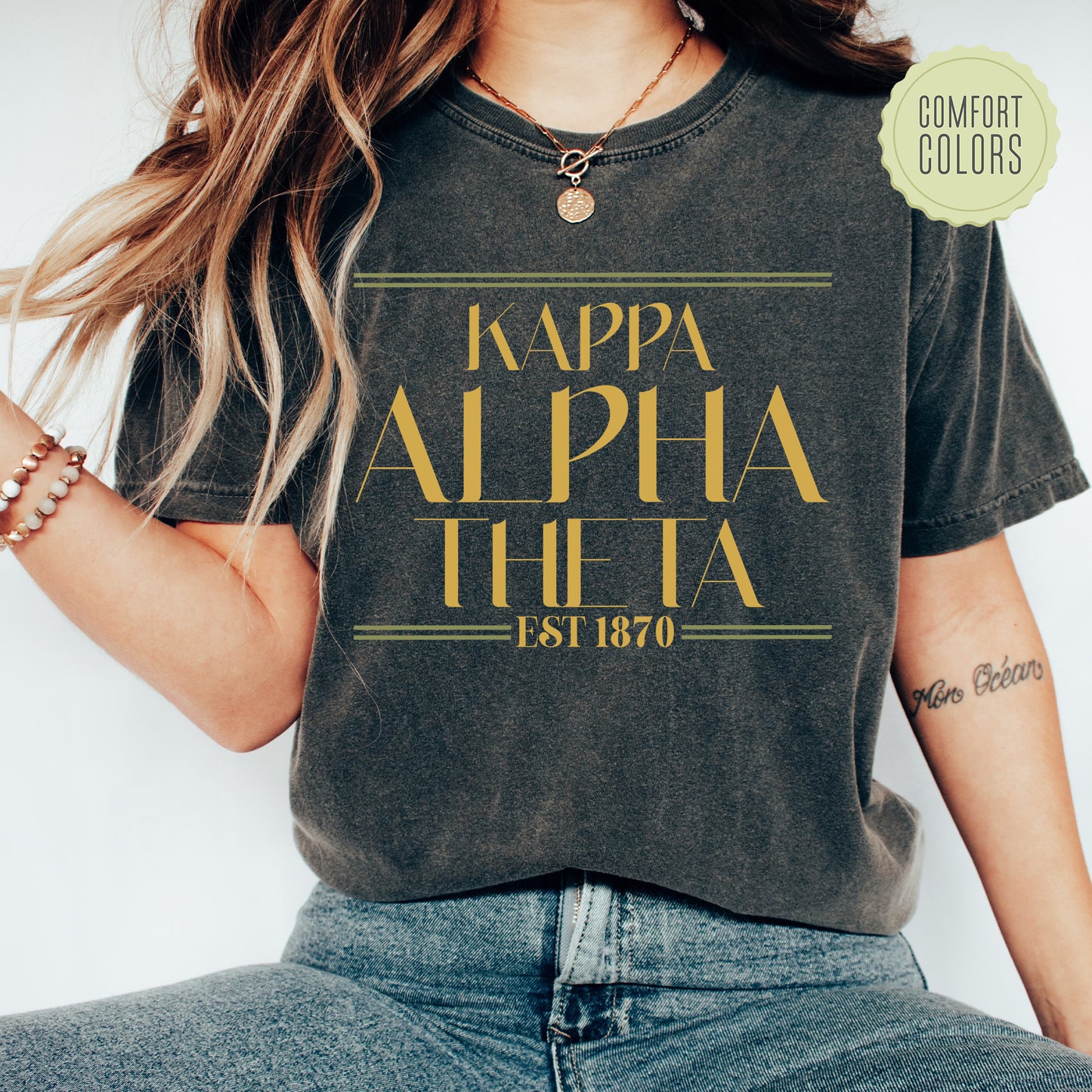 a woman wearing a t - shirt that says, kappa apha tho