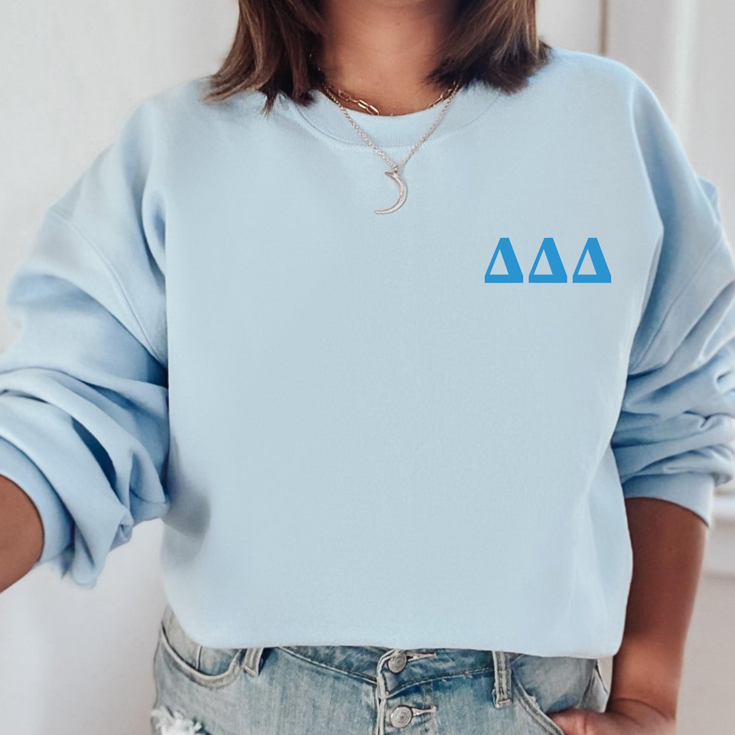 a woman wearing a blue sweatshirt with the letters aa on it
