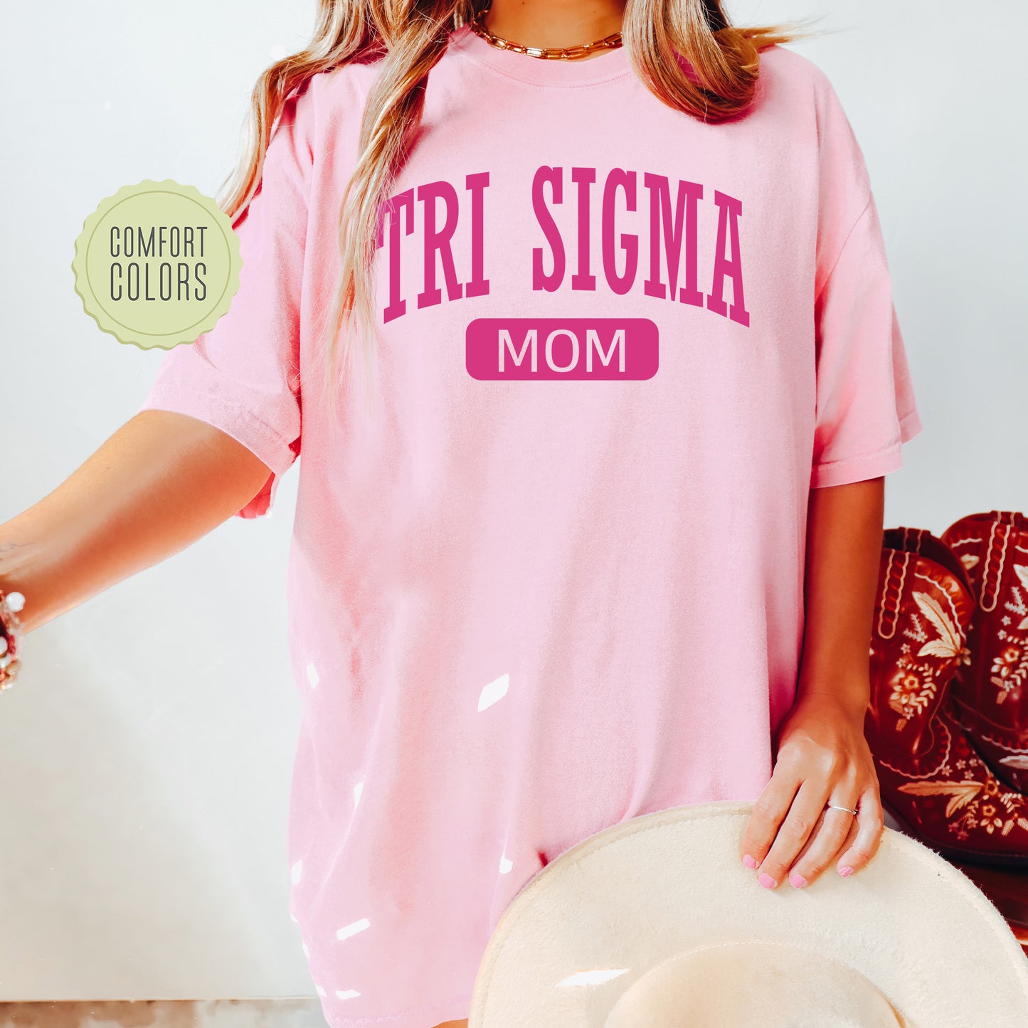 a woman wearing a pink shirt and hat